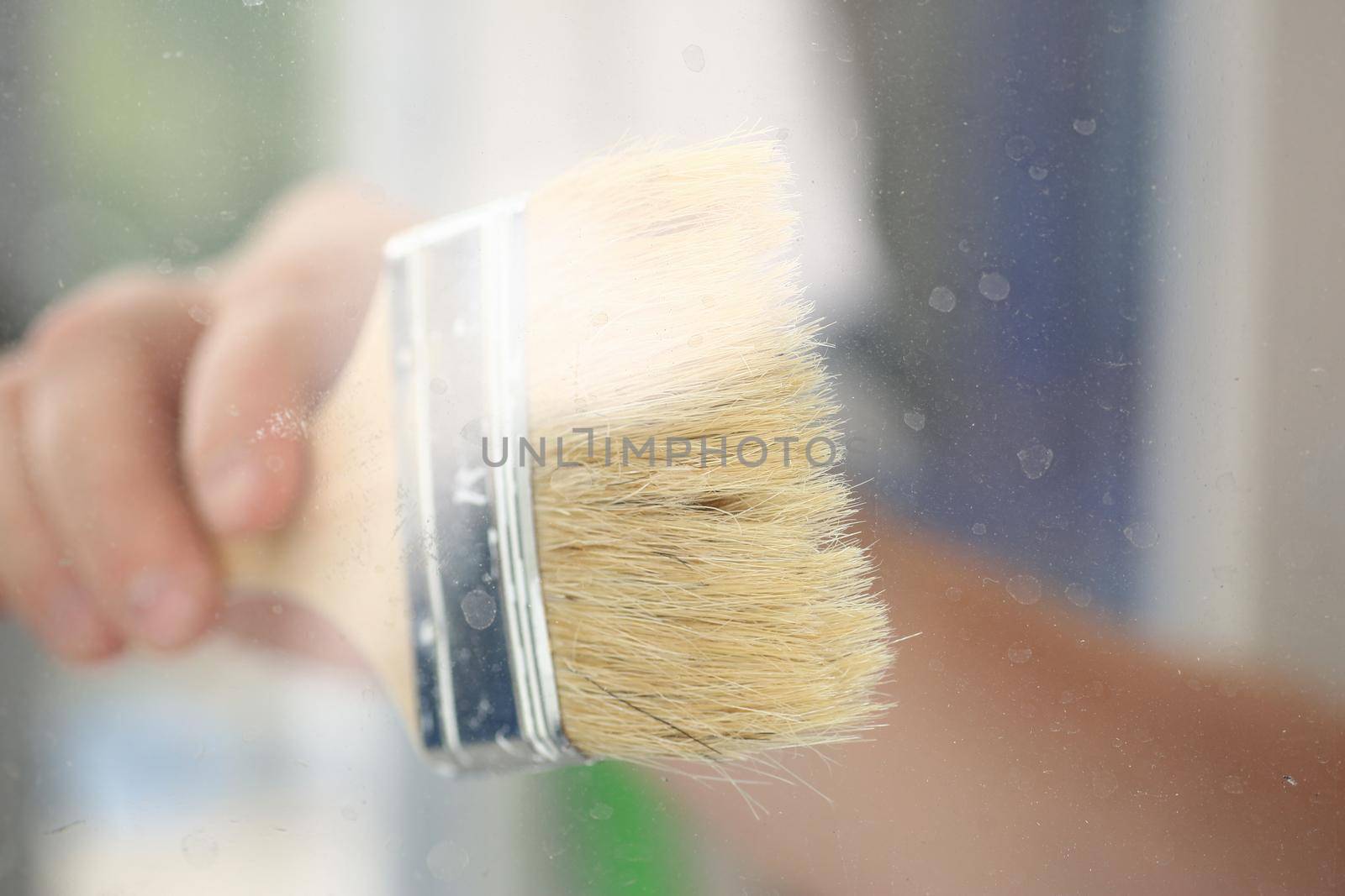 Arm of smiling worker hold brush closeup. Manual job workplace DIY inspiration improvement fix shop yellow helmet hard hat joinery startup idea industrial education profession career concept