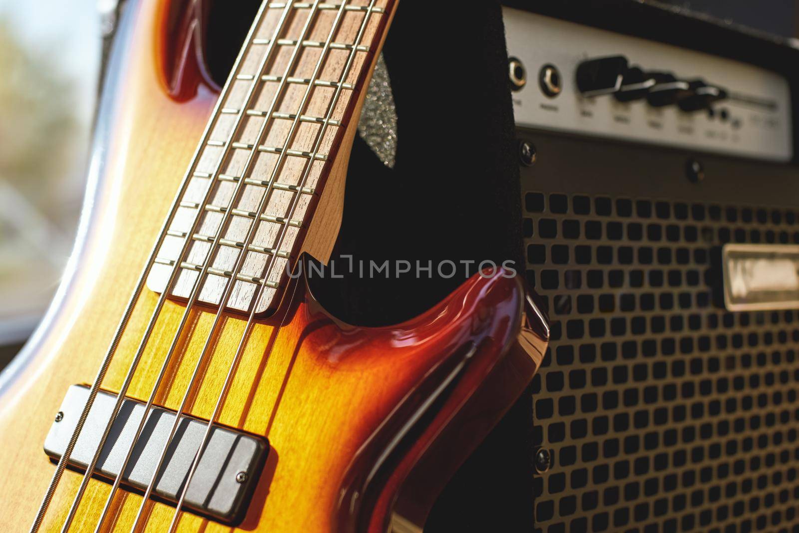 Playing Guitar. Close up view of brown electric guitar and amplifier. Music concept. Music equipment. Musical instruments.