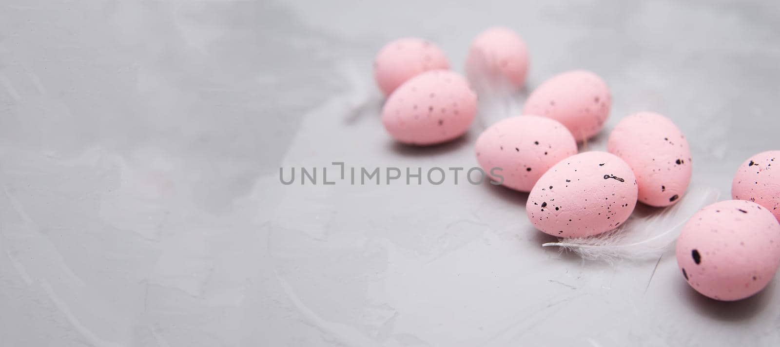 Easter background, pink quail eggs on gray background, flat lay, empty space for text. Happy Easter holiday.
