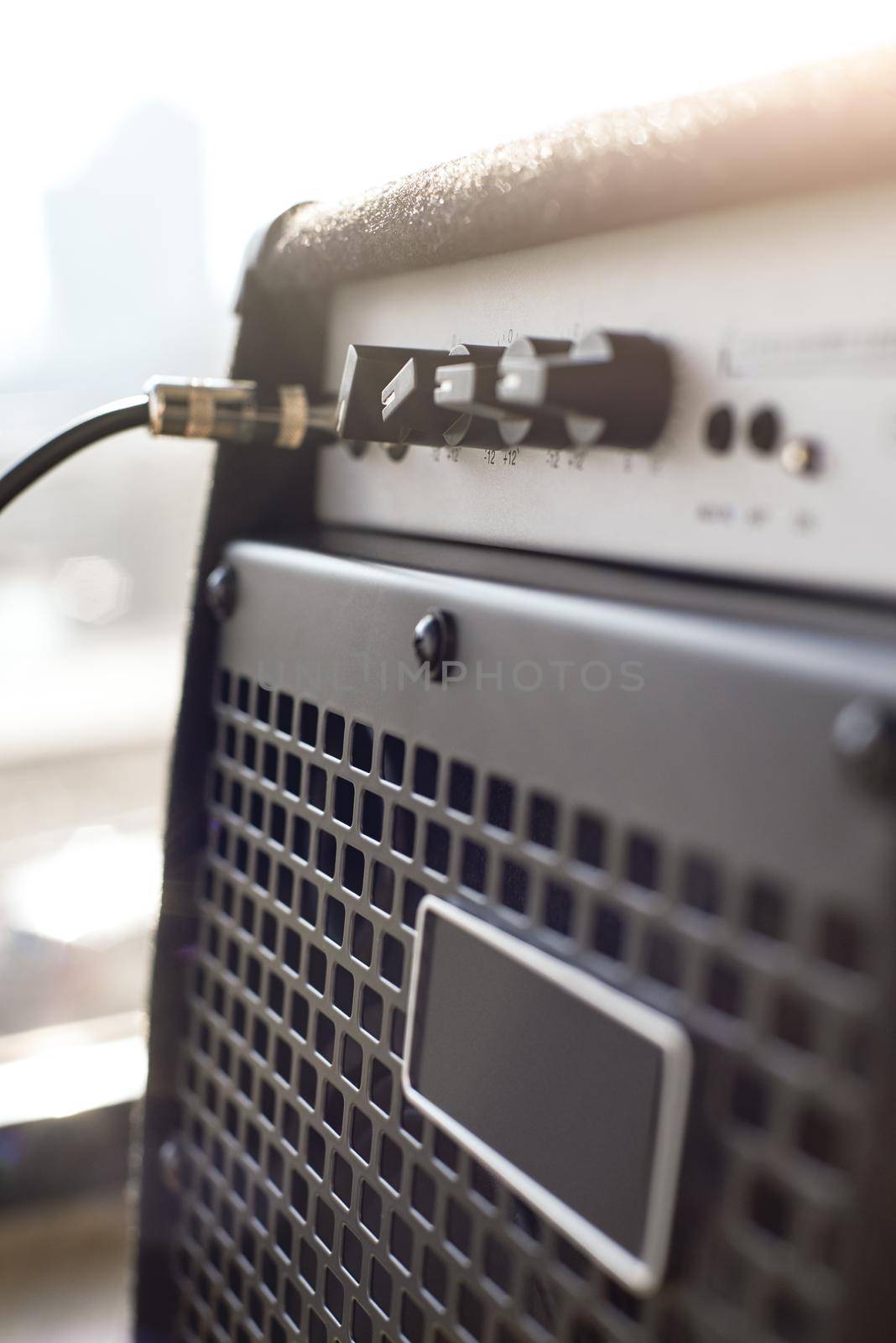 Choosing guitar amplifier. Vertical close-up view of guitar amplifier with cable audio jack. Musical instruments. Music equipment