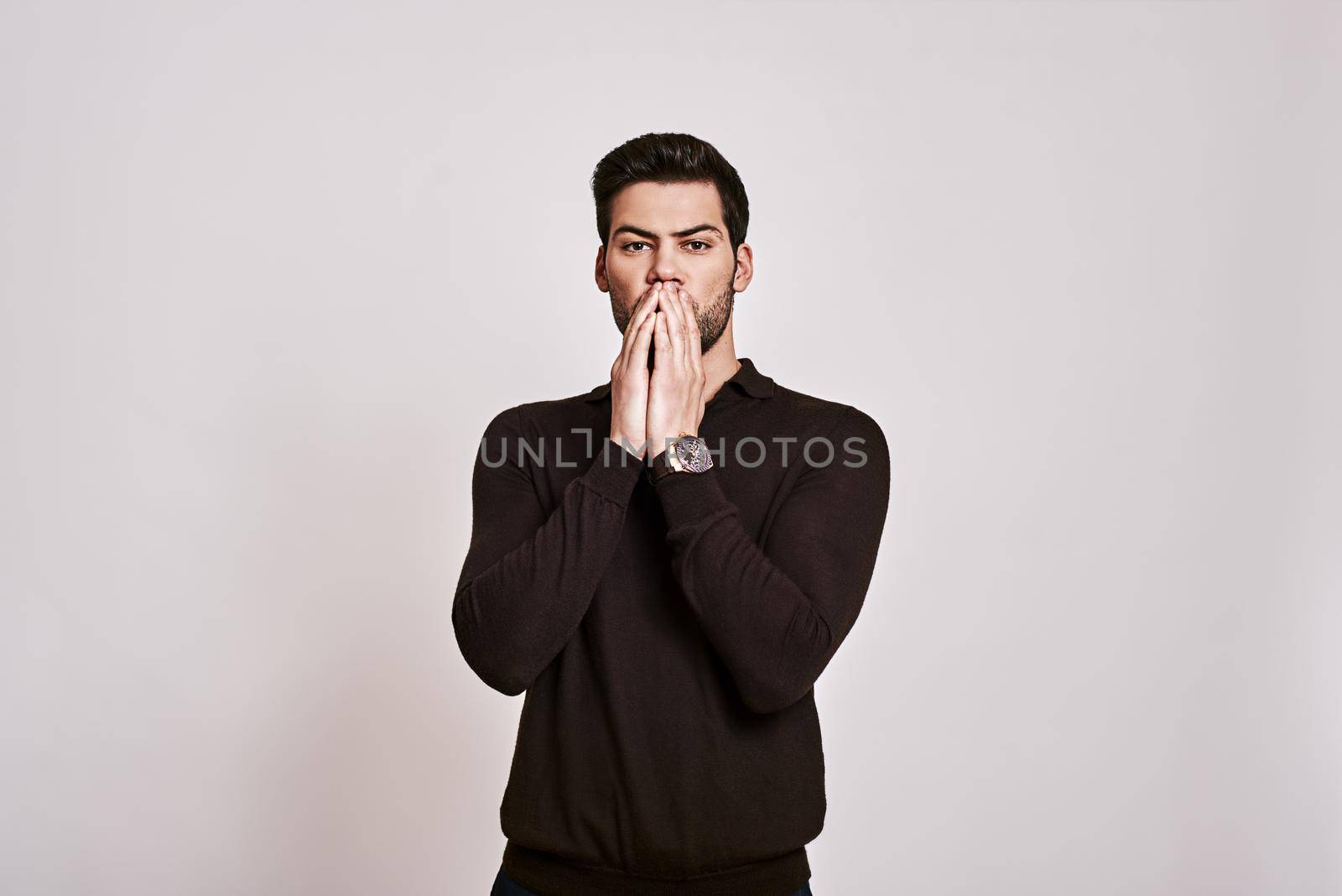 Oh my god Stylish dark-haired man standing in a state of shock and looking at camera isolated over grey background by friendsstock