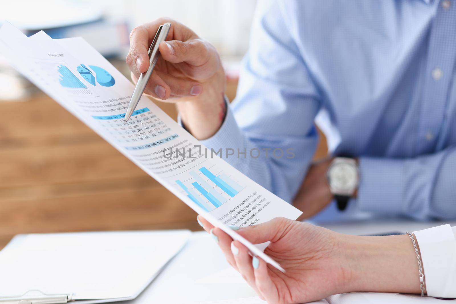 Group of people deliberate on problem with paper infographics hold in hand closeup. White collar check money papers stock exchange market earnings list partnership agreement discussion concept