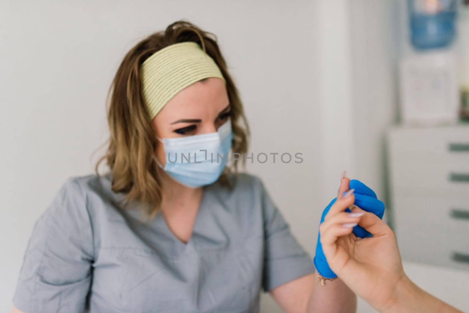 Female manicure master in beauty salon work with hands of the client