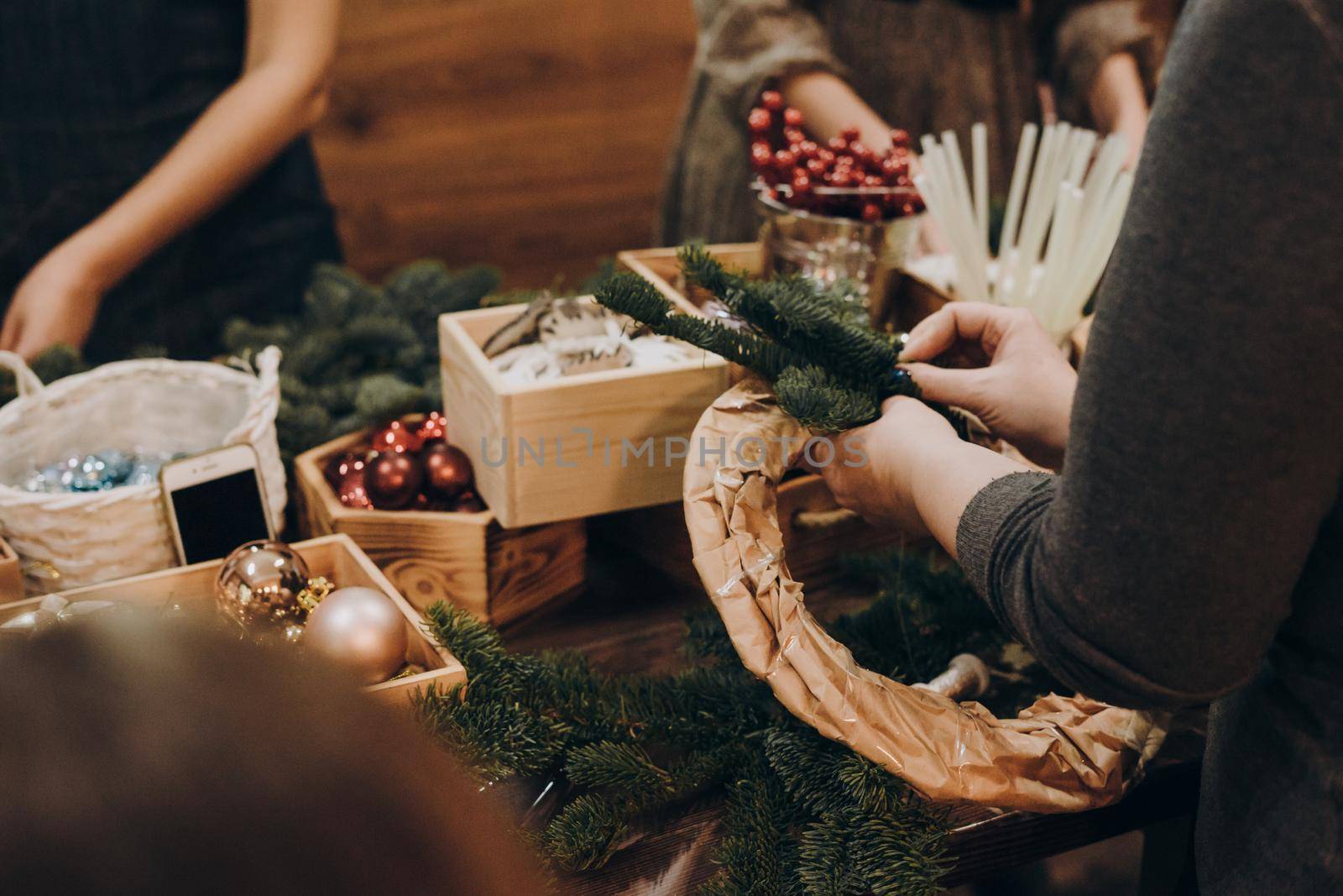 Woman making christmas wreath. A master class on creating a Christmas wreath from a natural spruce with your own hands. A Christmas wreath made with your own hands.