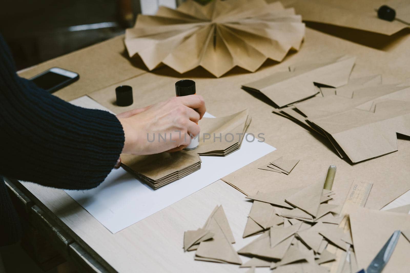 The origami stage. DIY personalized xmas decoration. Creating hand made christmas ornaments. Step by step instructions. Snowflake or three-dimensional star made of kraft paper.