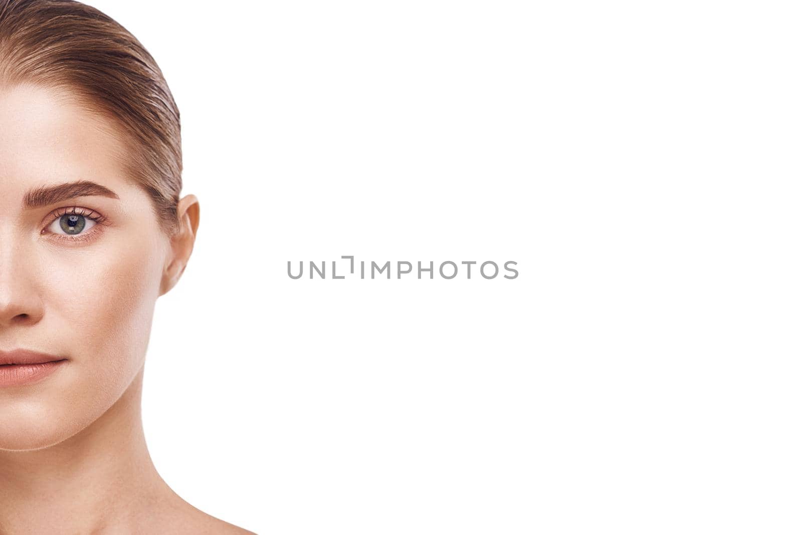 Half of beautiful woman face close-up studio on white. Cropped photo by friendsstock