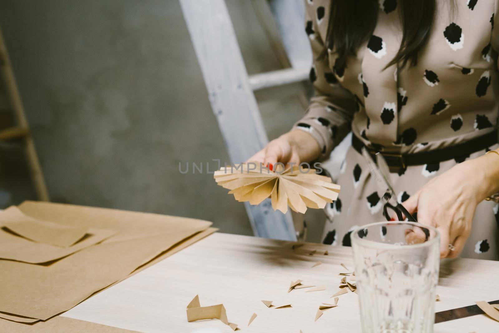 DIY personalized xmas decoration. Creating hand made christmas ornaments. Step by step instructions. Snowflake or three-dimensional star made of kraft paper.