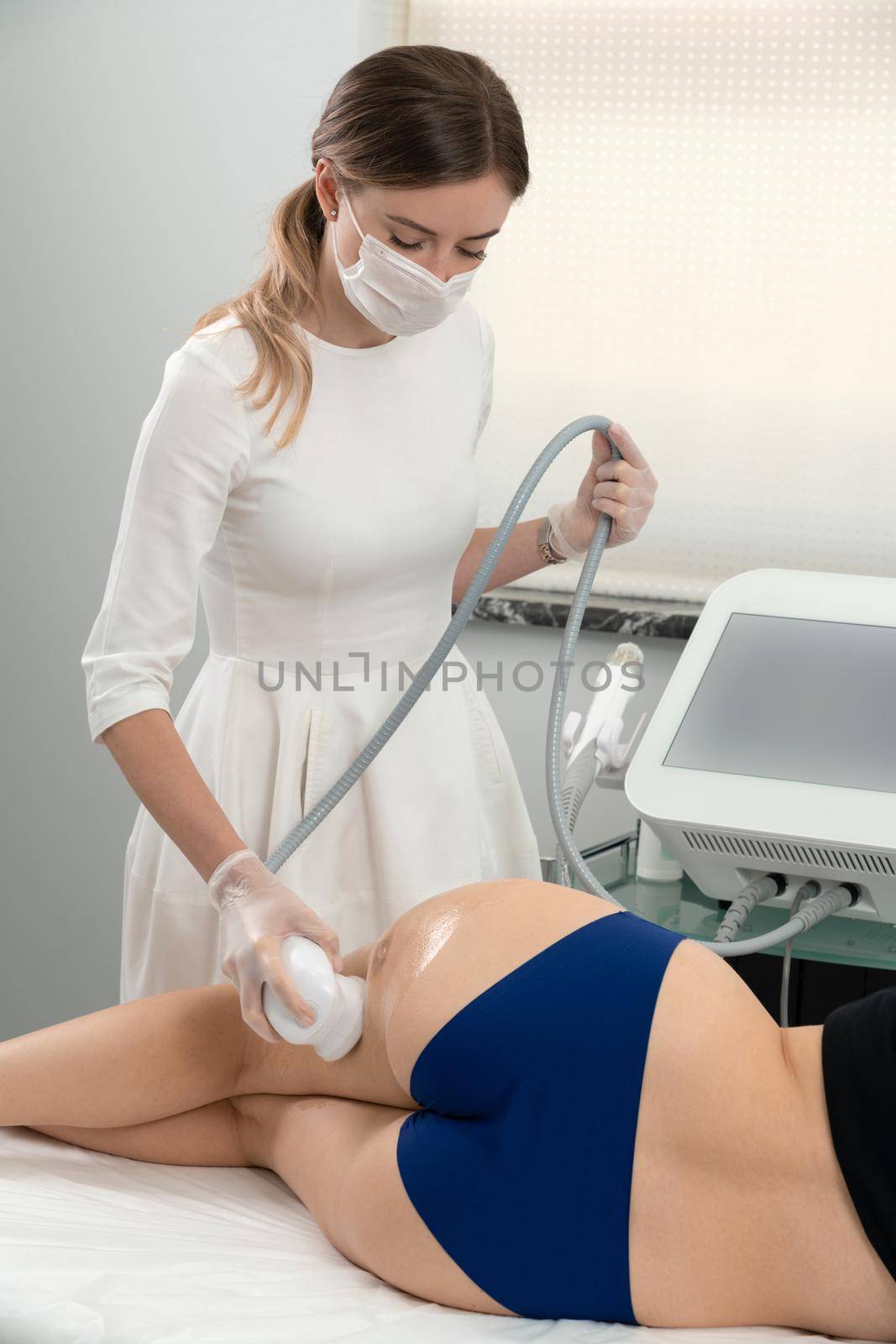 Ultrasound cavitation body contouring treatment. Woman getting anti-cellulite and anti-fat therapy in beauty salon by Mariakray