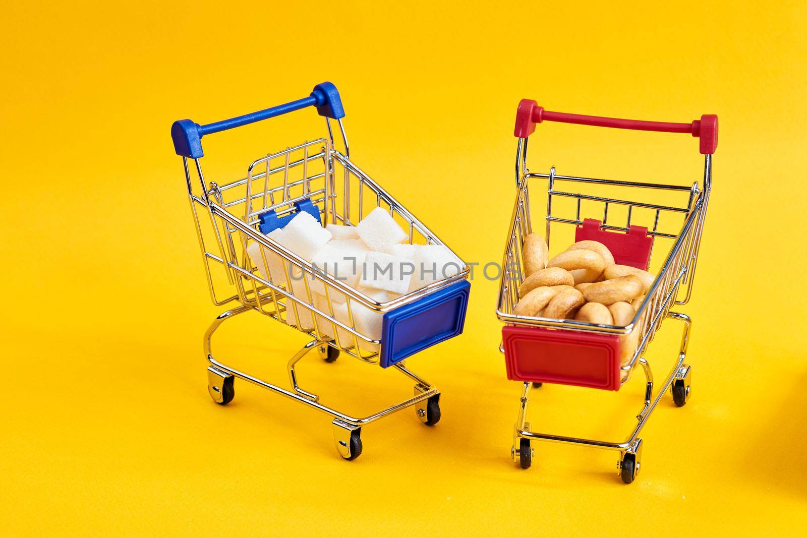 carts with groceries shopping supermarket store yellow background. High quality photo