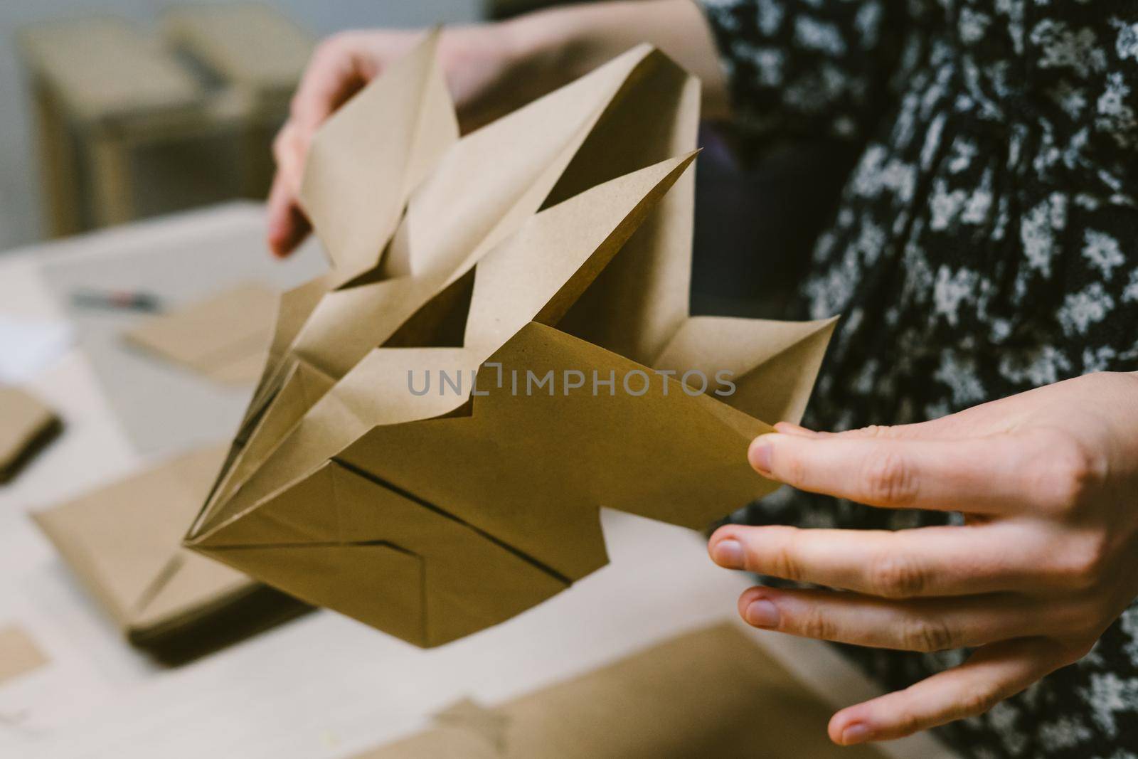 The origami stage. DIY personalized xmas decoration. Creating hand made christmas ornaments. Step by step instructions. Snowflake or three-dimensional star made of kraft paper.