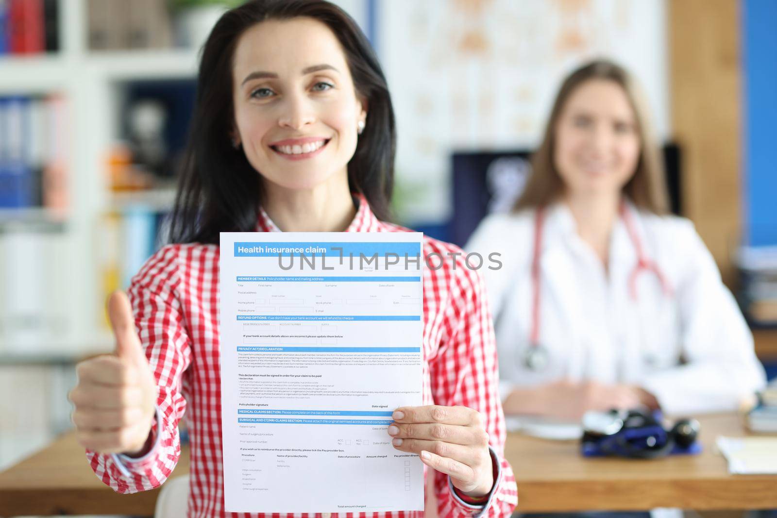 Happy woman shows document about health insurance, close-up. Insured event, doctor's consultation. Health expenses
