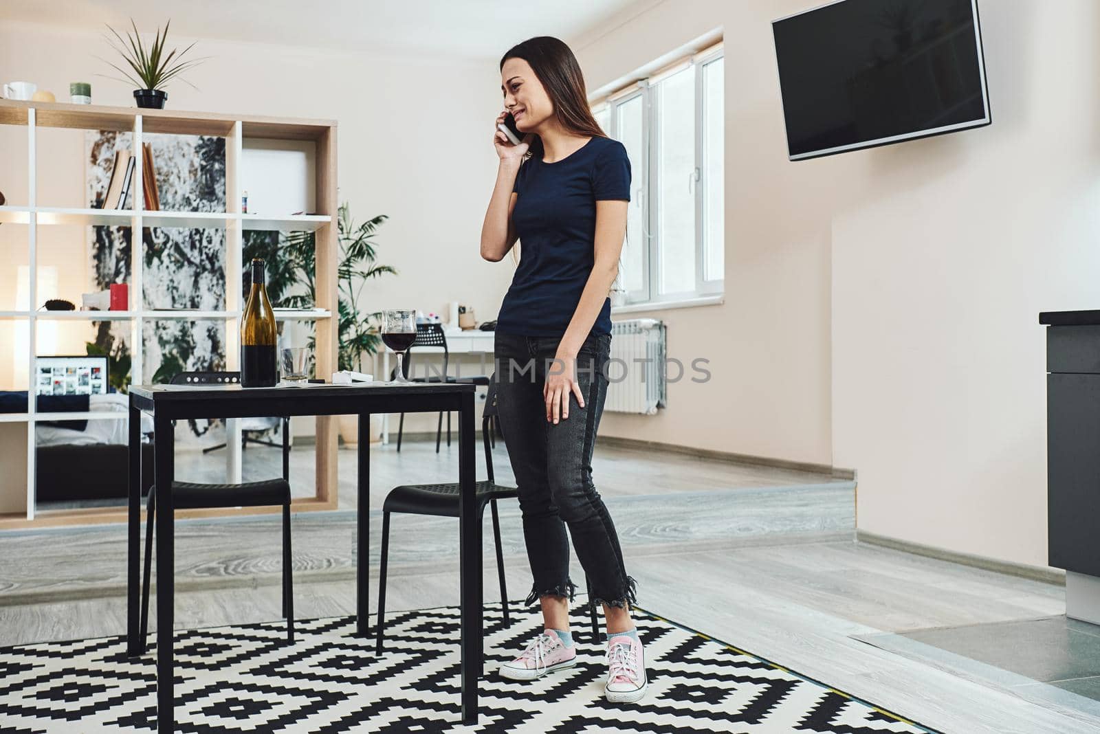 Recovery is all about using our power to change our beliefs that are based on faulty data. Young addicted, depressed woman standing in the kitchen, looking away and crying by friendsstock