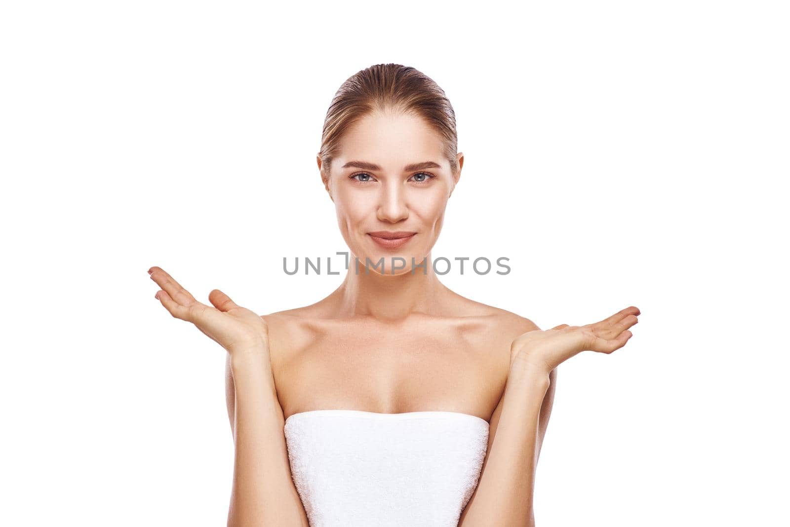 Beautiful womans face and hands, close-up studio photo on white background. Light hair, grey eyes. She is wearing white towel