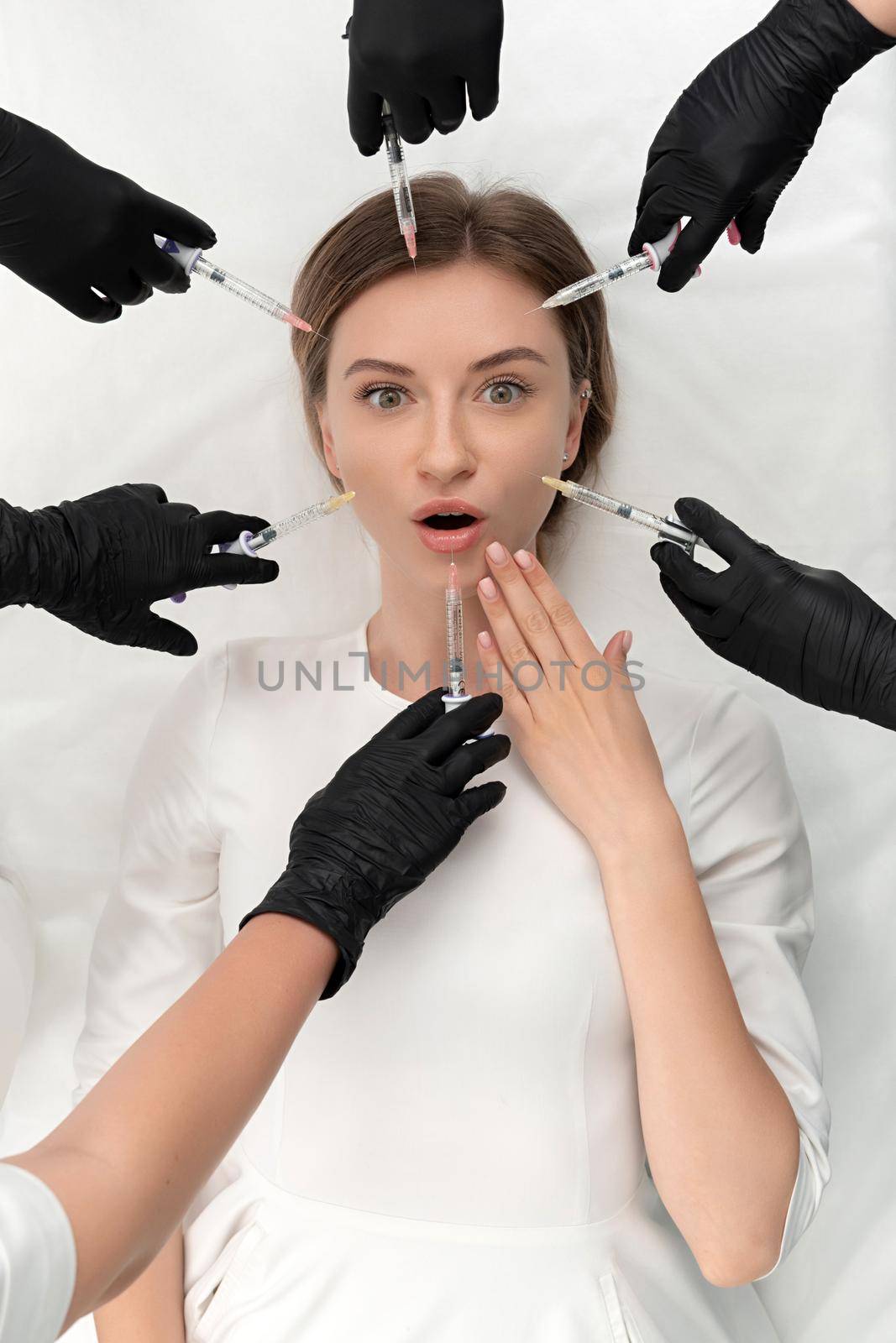Conceptual beauty and cosmetology image of hands of several doctors holding syringes. Beauty and Cosmetology concept. Cosmetic procedures mesotherapy by Mariakray