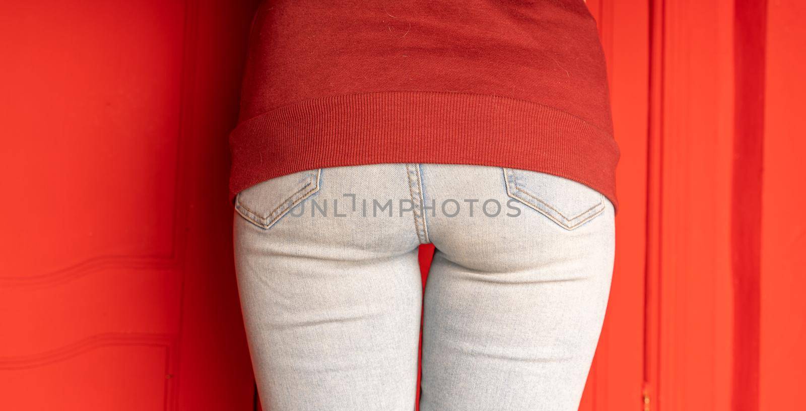 Close up of female buttocks in jeans. Rear view on buttocks of unrecognizable woman. by epidemiks