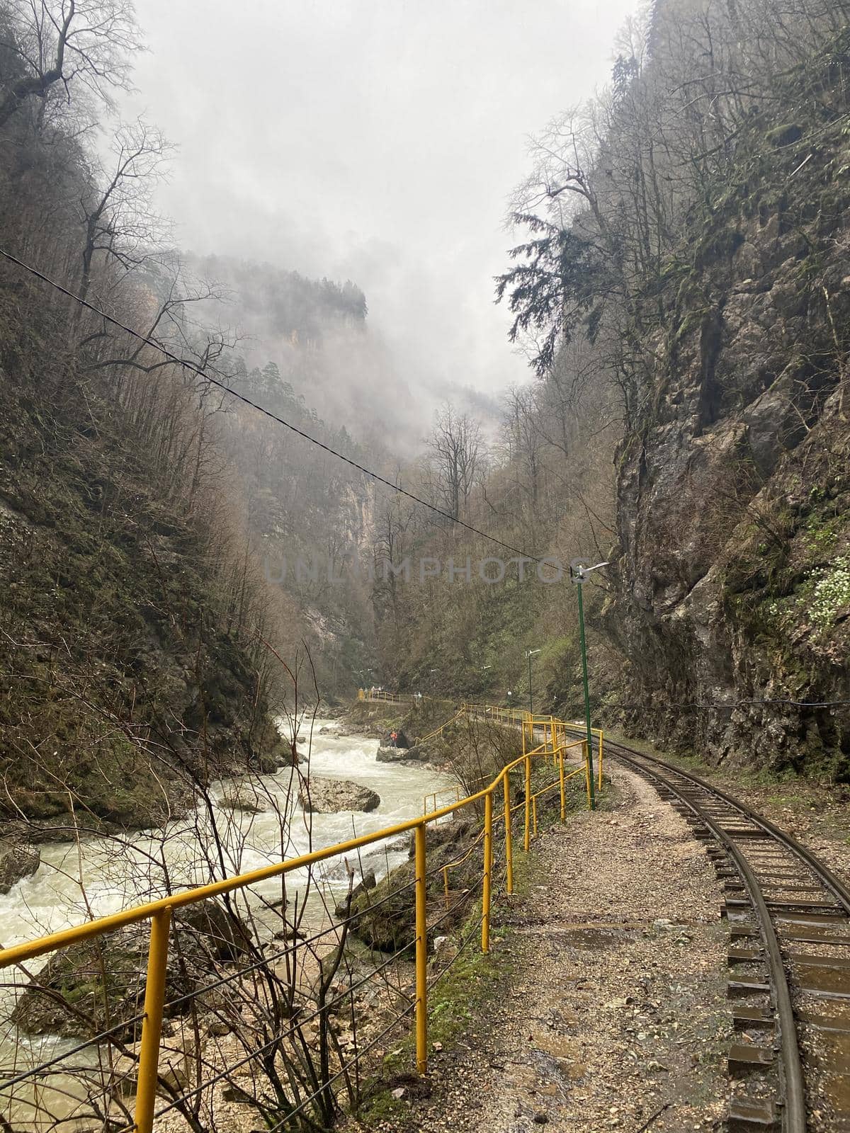 Close up of railway in mountainous terrain. Railway track in rainy weather in amazing and mysterious nature. by epidemiks