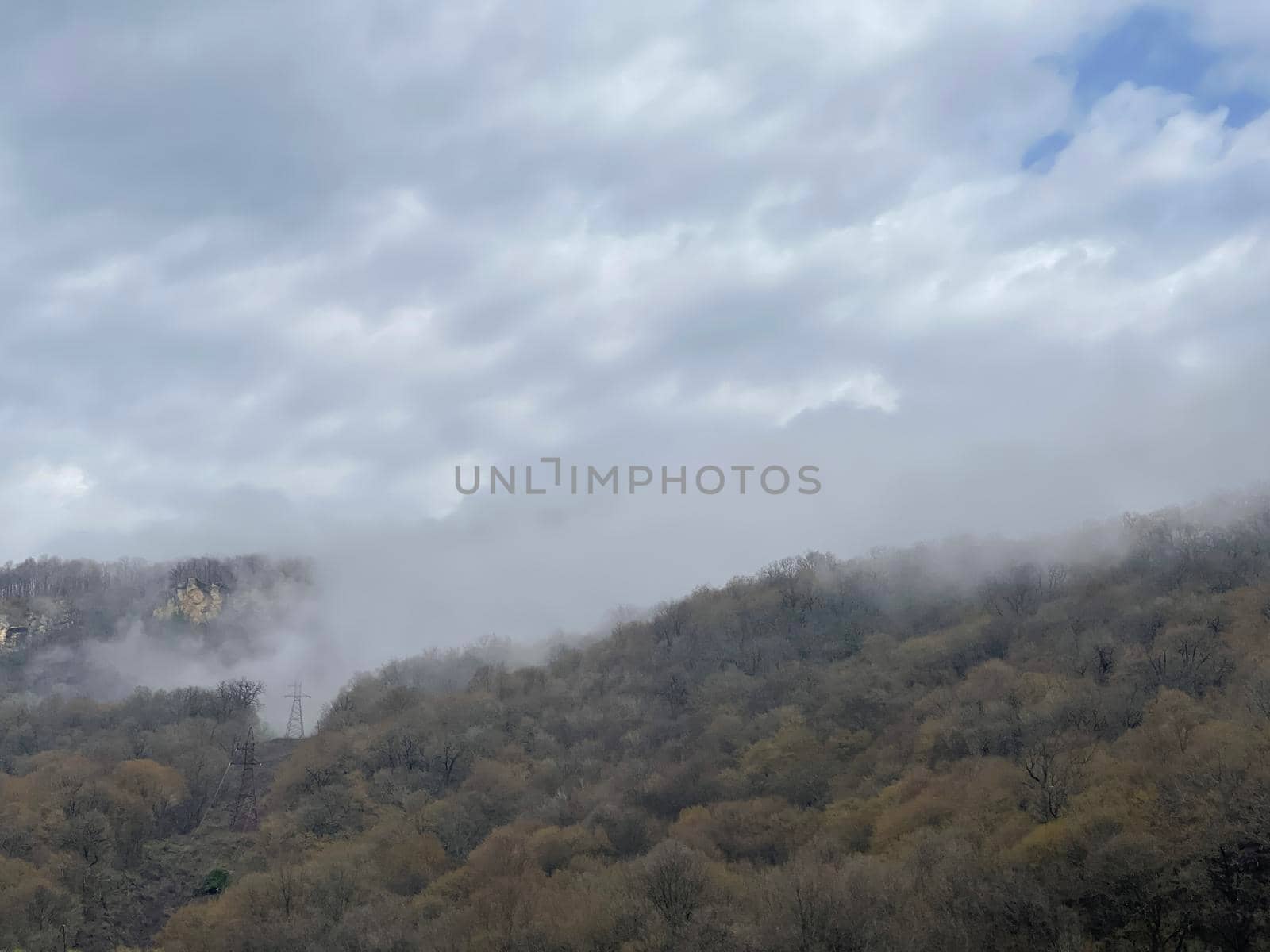 Beautiful landscape of mountainous terrain in fog. Nature background of hilly area in foggy and cloudy weather. by epidemiks