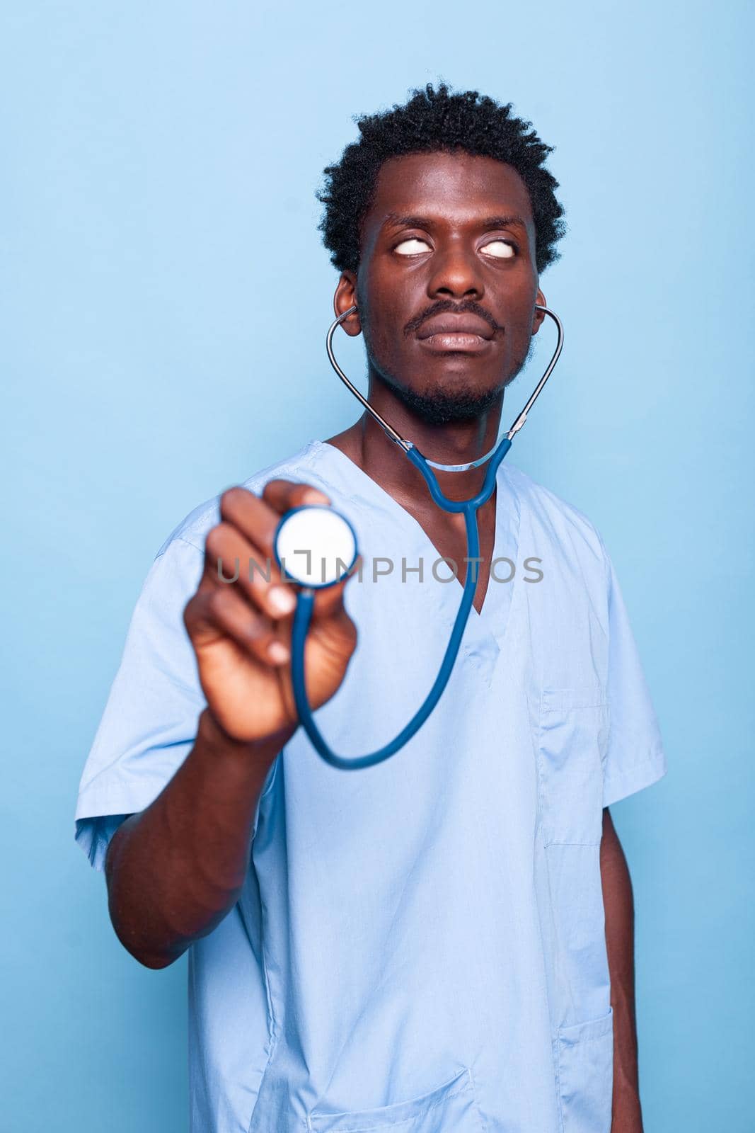 Goofy nurse holding stethoscope while rolling eyes by DCStudio