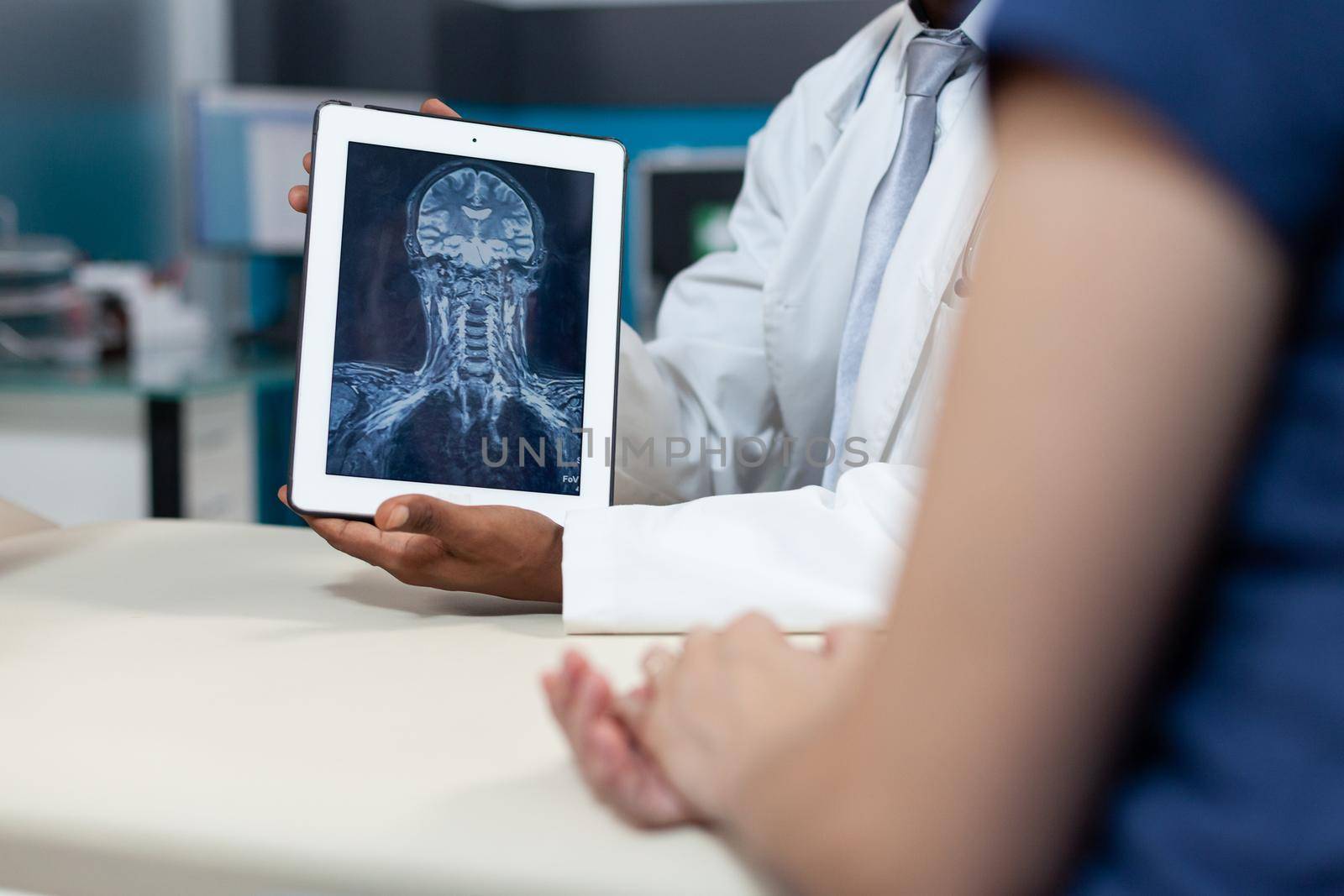 Closeup of african american radiologist holding tablet with bones radiography by DCStudio
