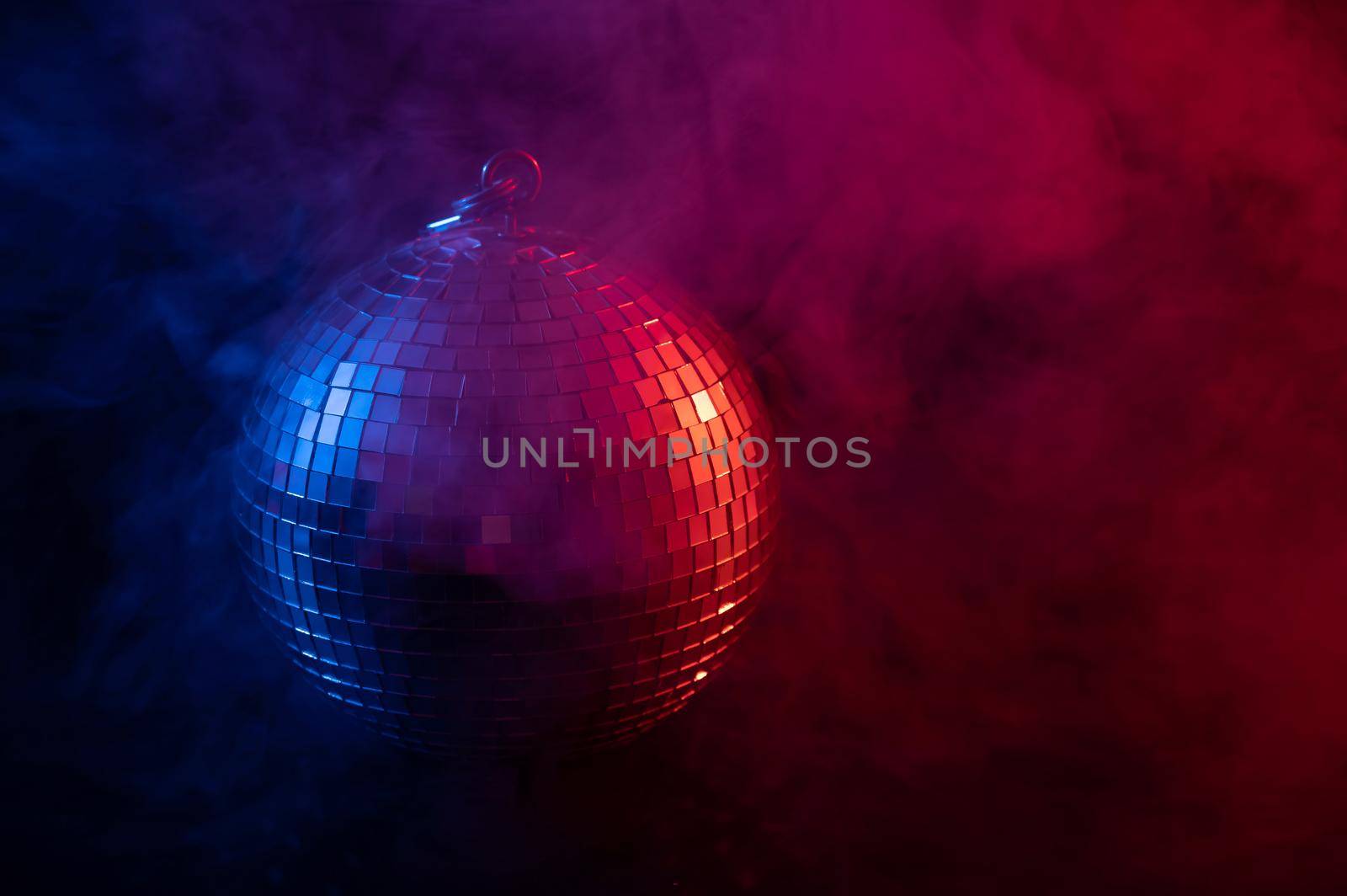 The disco ball is spinning in pink-blue smoke. Night life. by mrwed54
