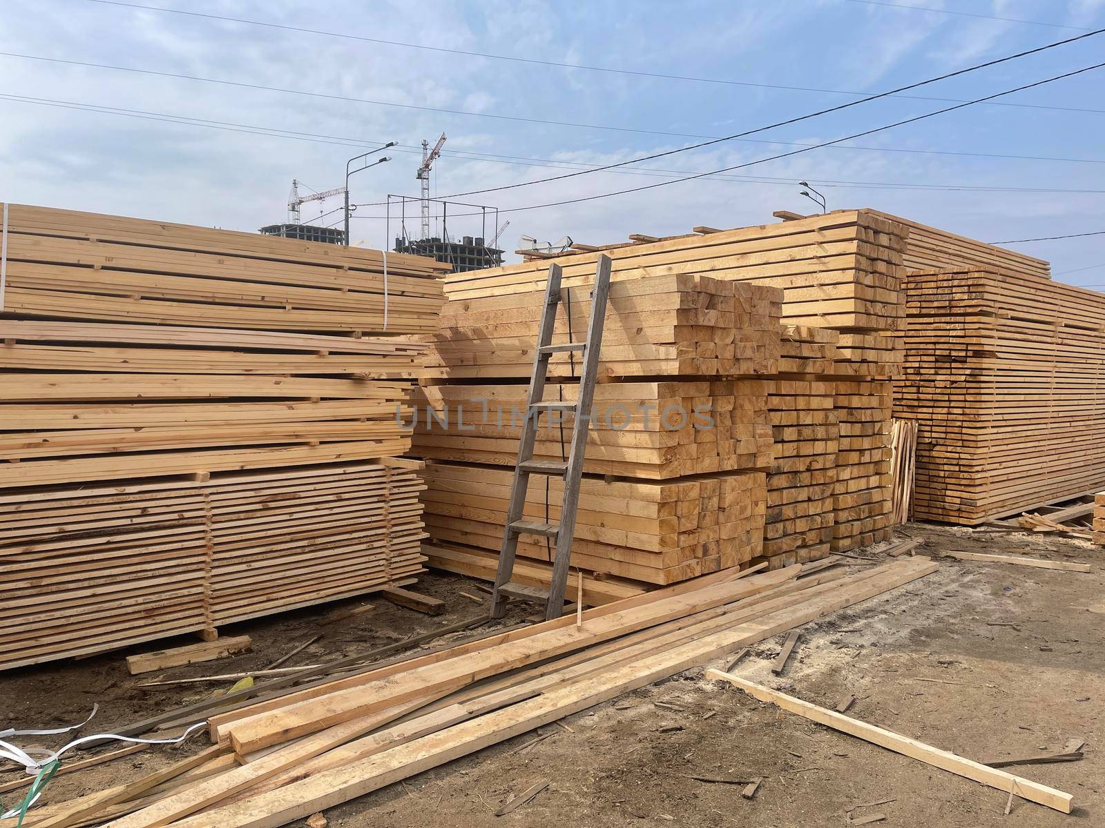 Wooden boards, lumber, industrial wood, timber. Pine wood timber stack of natural rough wooden boards on building site. Industrial timber building materials by epidemiks