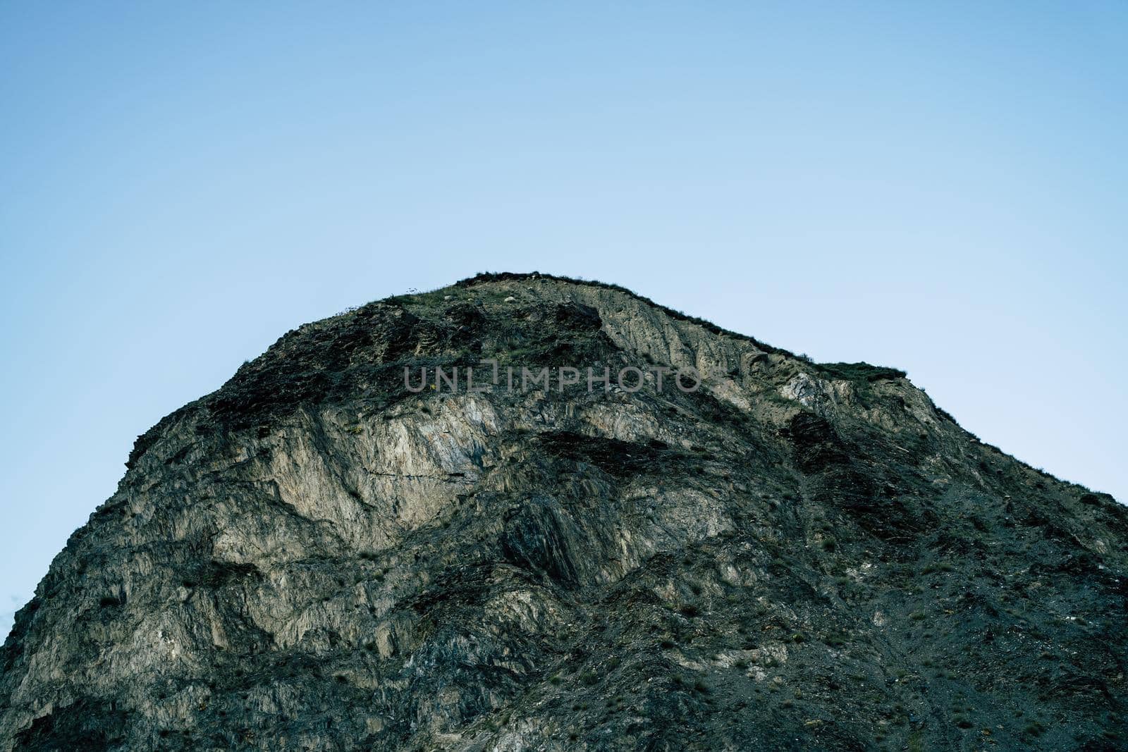 Close up of mountain top on background of blue sky. Mountain landscape in clear weather in summertime. by epidemiks