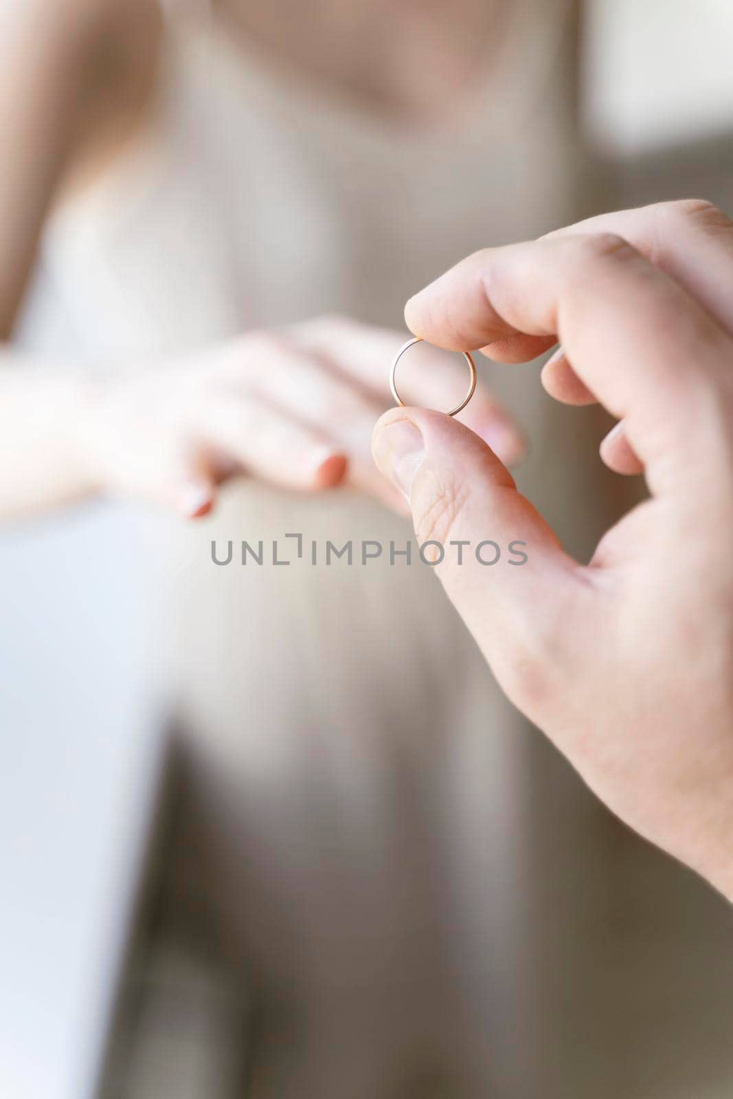 the groom puts the ring on the bride's finger. wedding by Lena_Ogurtsova