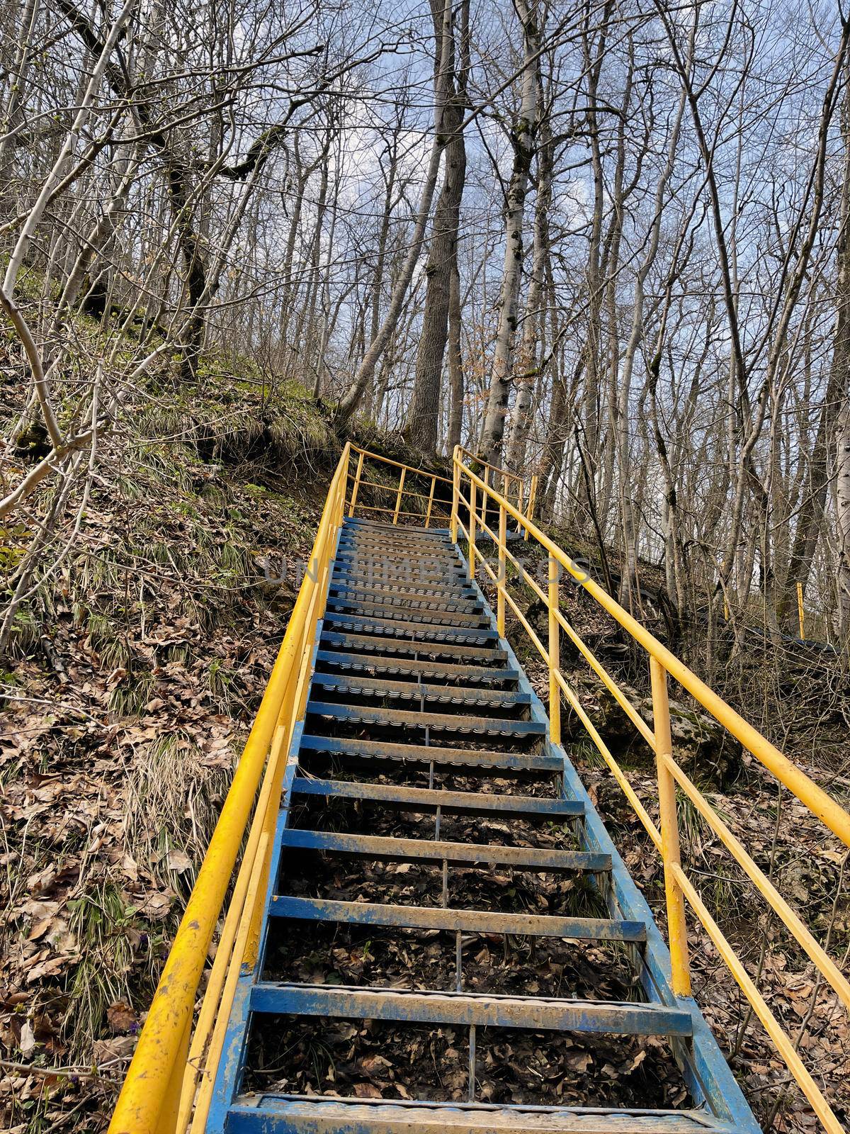 Close up of metal staircase in woodland. Metal stairway to overcome obstacles in mountainous terrain
