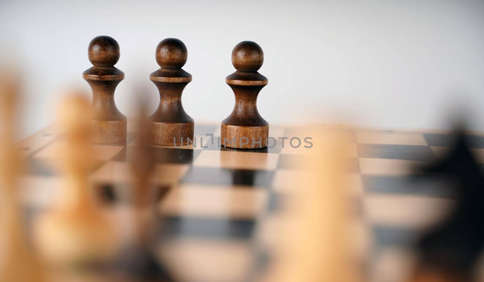 Close-up of chess on a gray background. Wooden chess pieces. Concept: the Board game and the intellectual activities by epidemiks