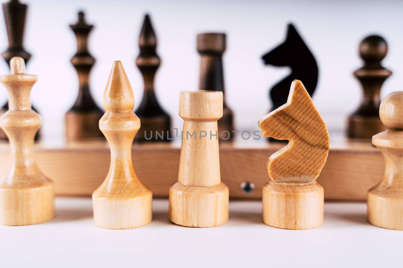 Close-up of chess on a gray background. Wooden chess pieces. Concept: the Board game and the intellectual activities.