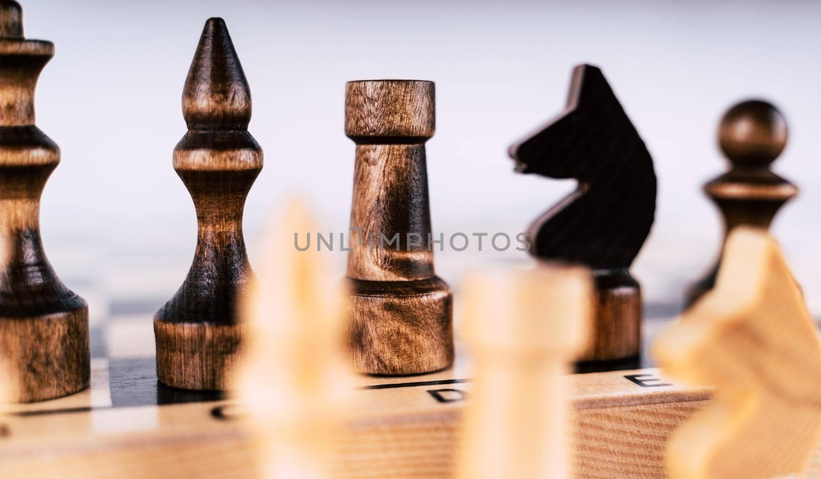 Close-up of chess on a gray background. Wooden chess pieces. Concept: the Board game and the intellectual activities by epidemiks