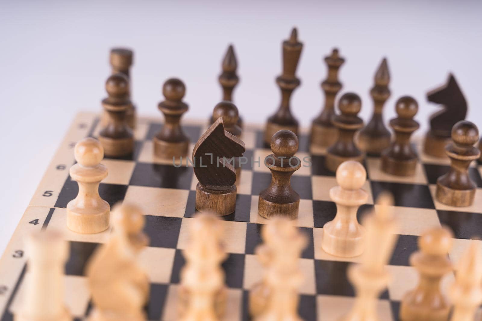 Close-up of chess on a gray background. Wooden chess pieces by epidemiks