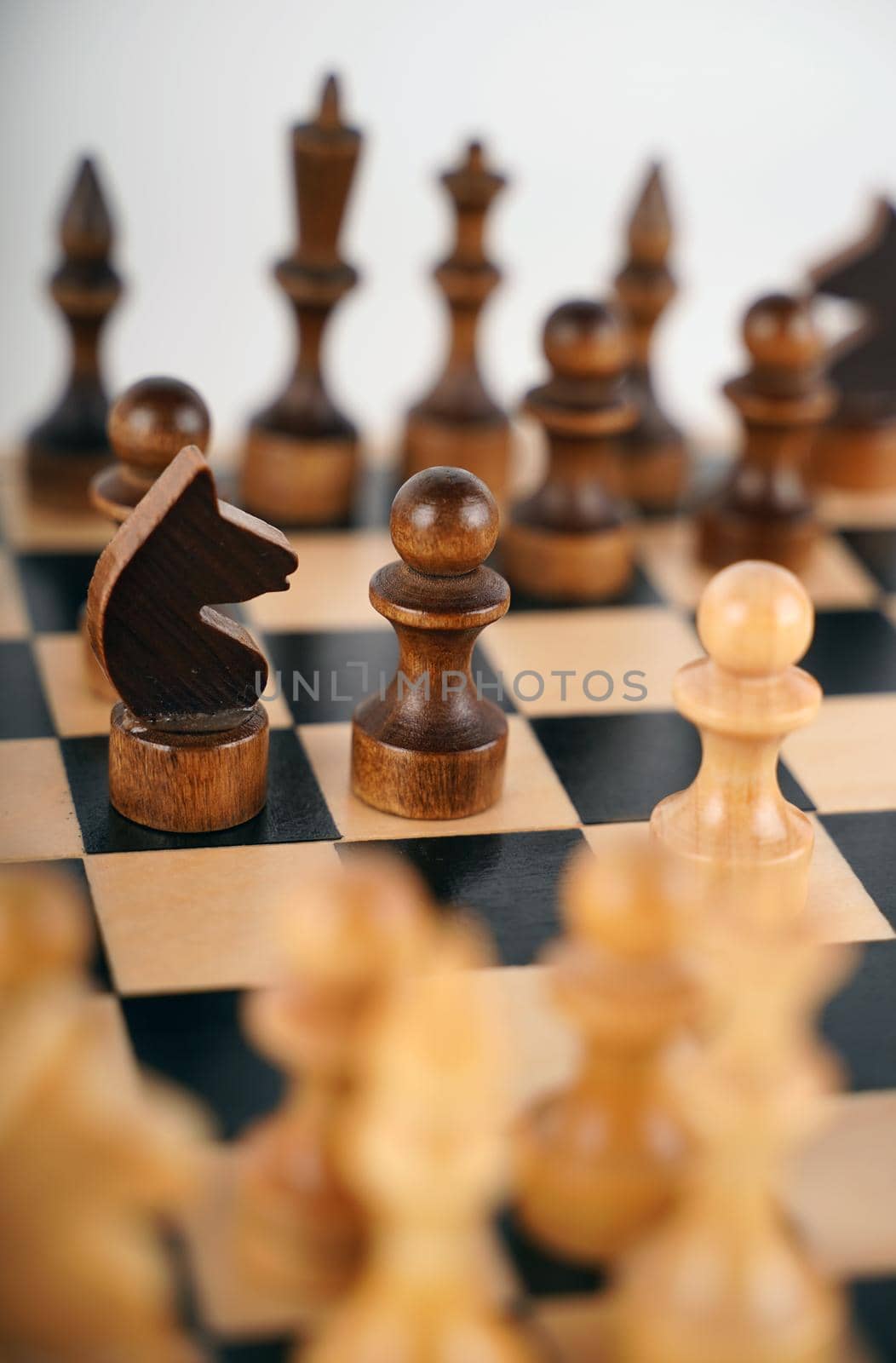 Close-up of chess on a gray background. Wooden chess pieces. Concept: the Board game and the intellectual activities.