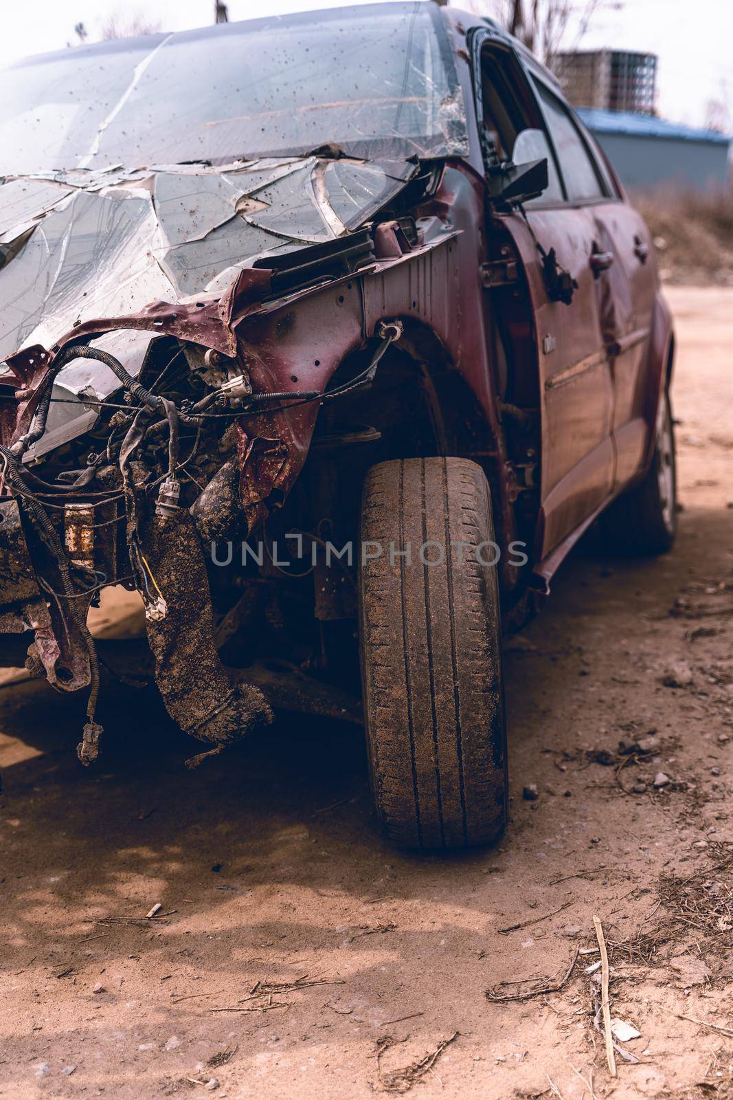 Close up of broken and abandoned car. Smashed car to pieces after accident on street. Concept of careless driving