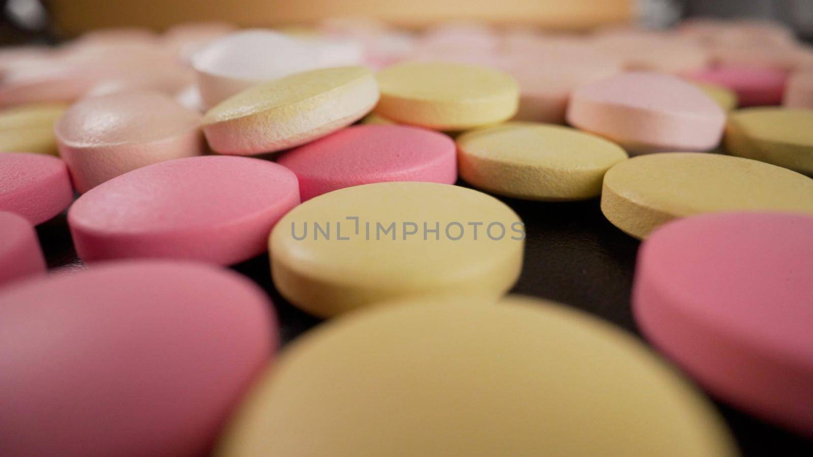 Close-up of a set of multicolored pills slowly rotating. Multicolored pills close-up. by Rusrussid