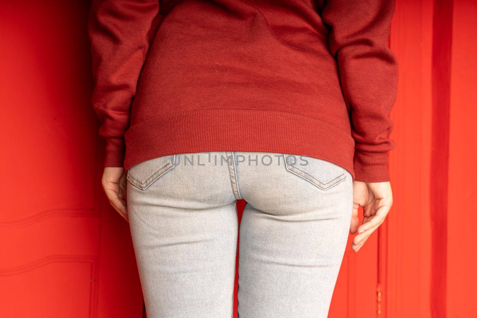 Close up of female buttocks in jeans. Rear view on buttocks of unrecognizable woman. by epidemiks