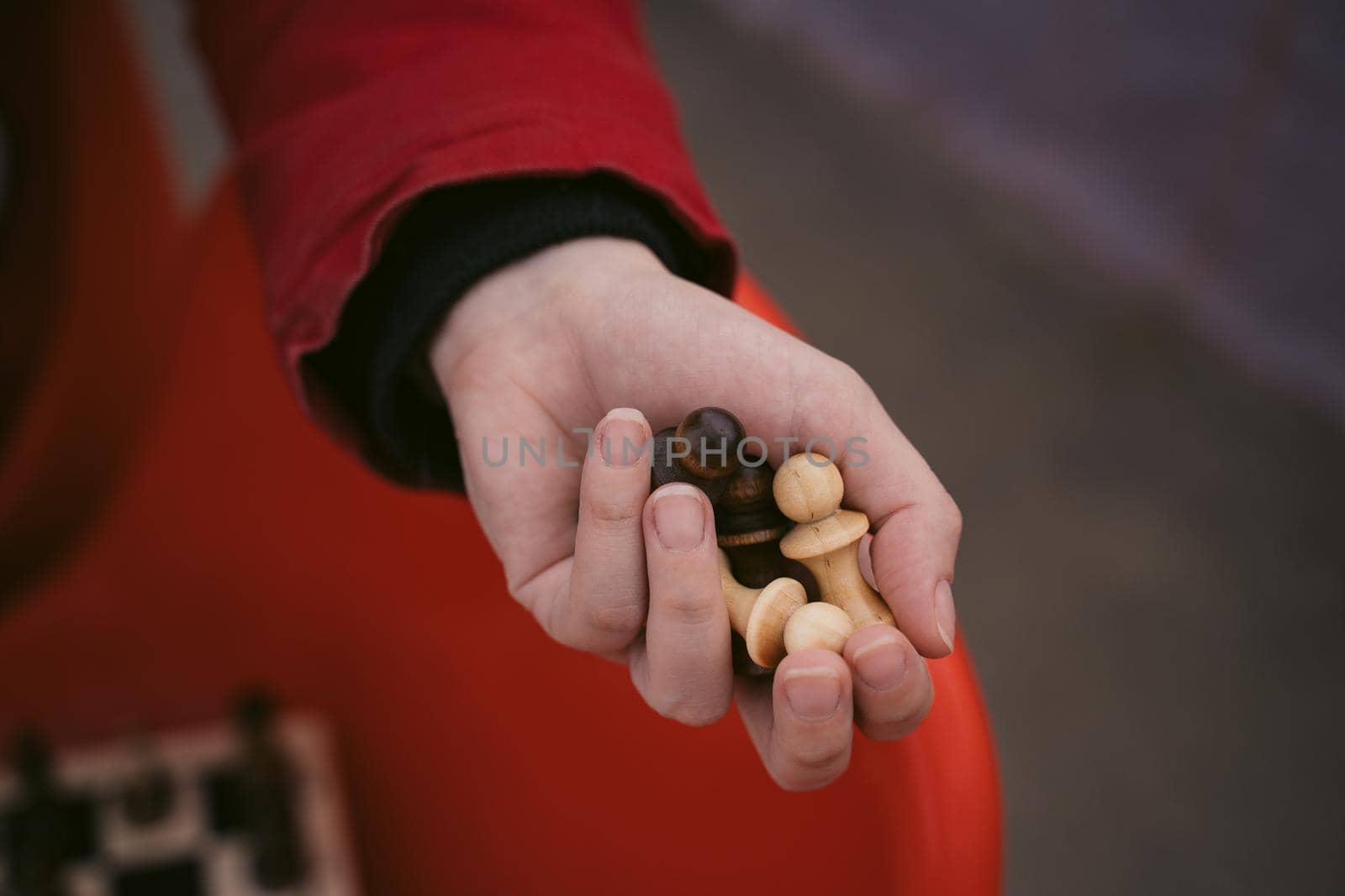 Close up of chess pieces in hand of unrecognizable woman. Unknown female holds figures of chess in her hands by epidemiks