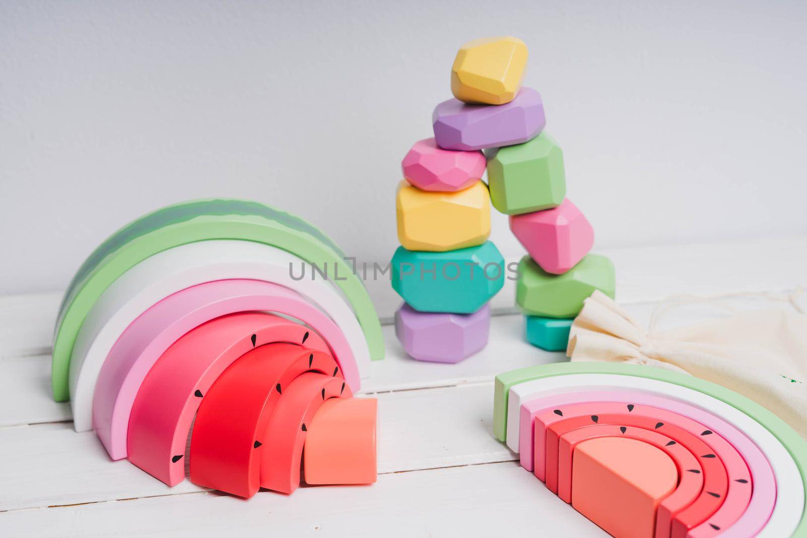 Wooden cubes with different faces for the development of coordination and balancing. Bright toys for children made of natural wood. Wooden rainbows in the form of a watermelon. Zero waste.