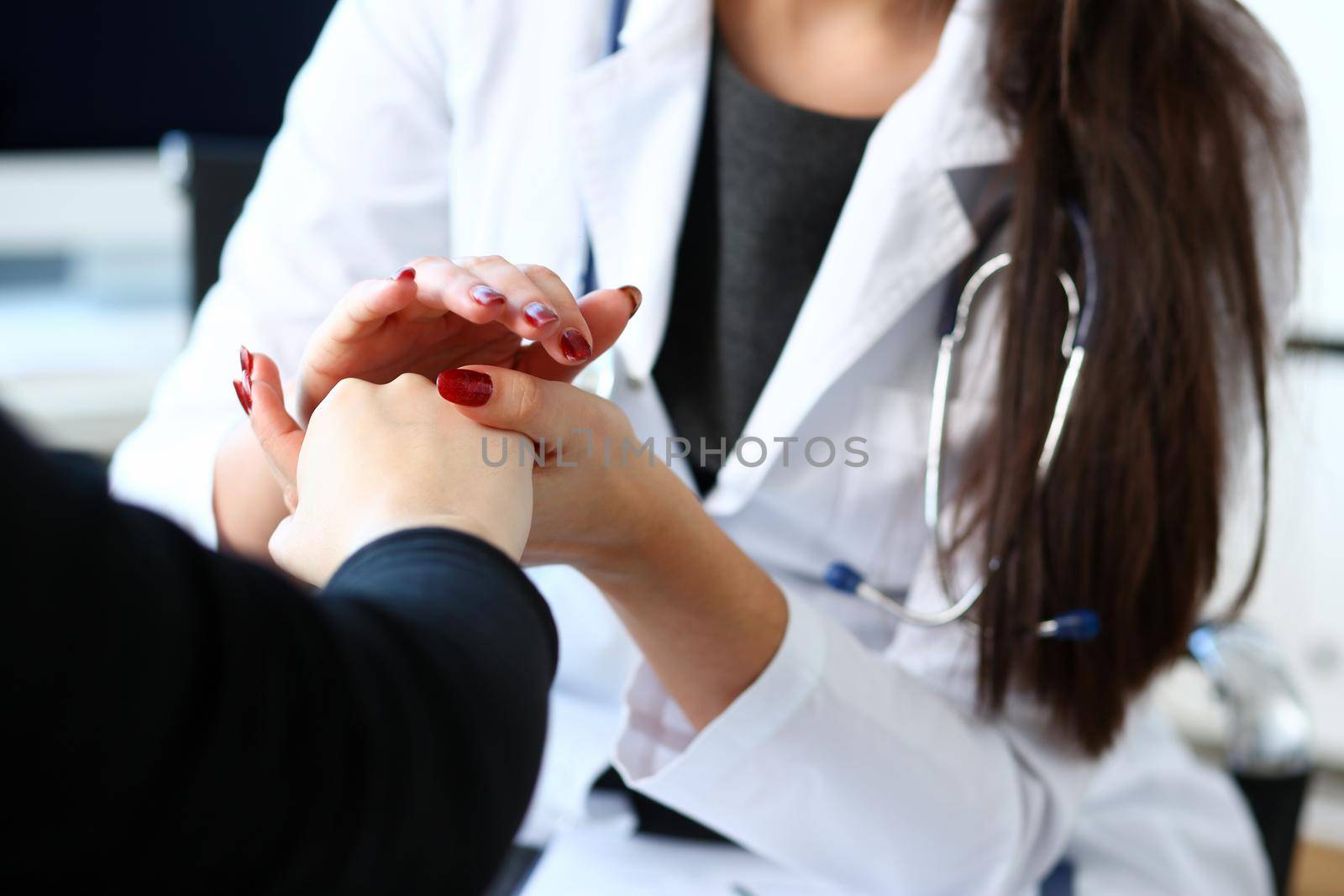 Young female doctor holds sick patient by hand expressing condolences and sympathy reports bad news about loss of loved ones due to cancer deadly aids disease and says we can handle support concept.