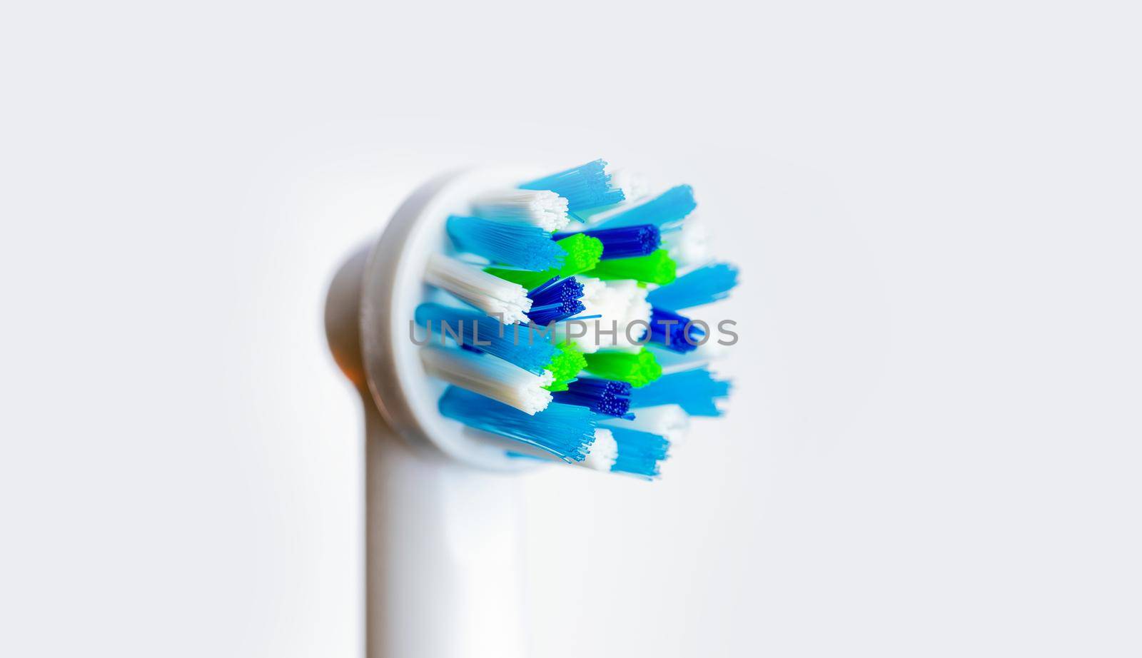 Close up of electric toothbrush on white background. Head of toothbrush for oral hygiene. Dental concept of healthy and clean teeth