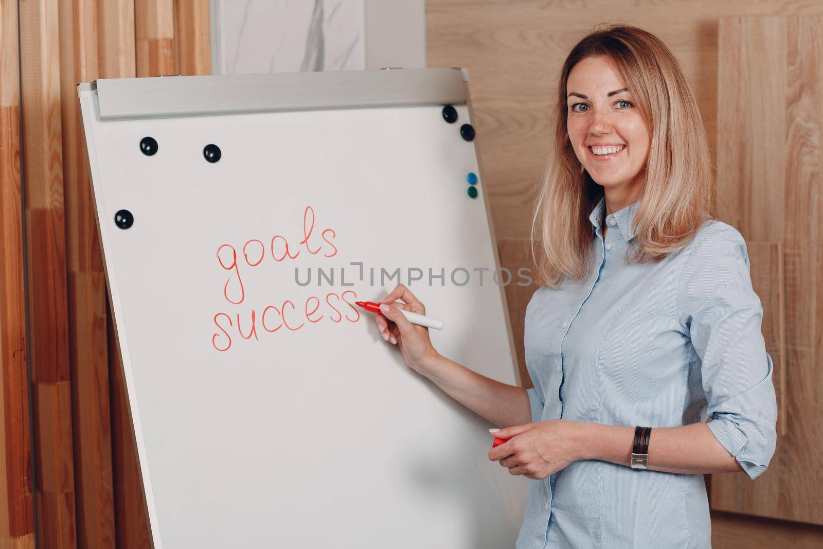 Business woman young adult coach at office with whiteboard