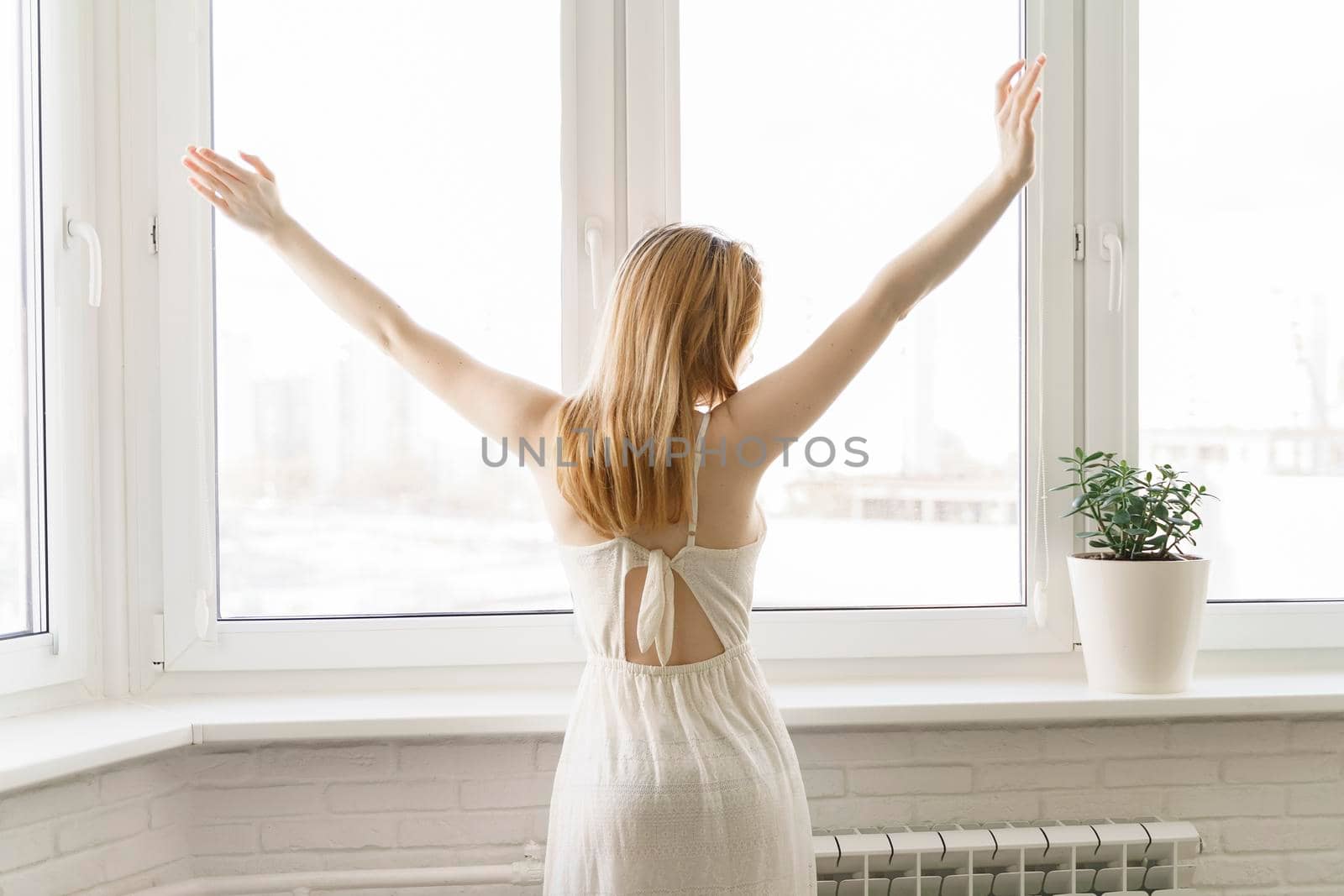 Rear view image of a woman do stretching after waking up in the morning by Lena_Ogurtsova