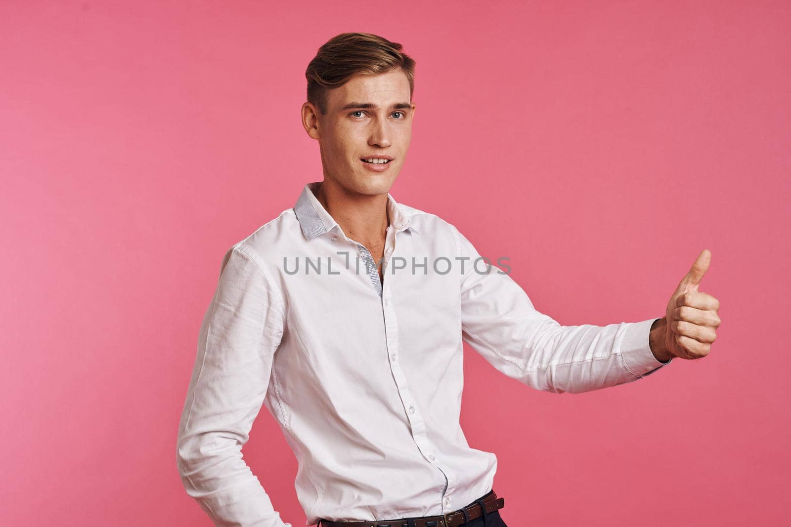 handsome man posing white shirt fashion self confidence studio lifestyle. High quality photo