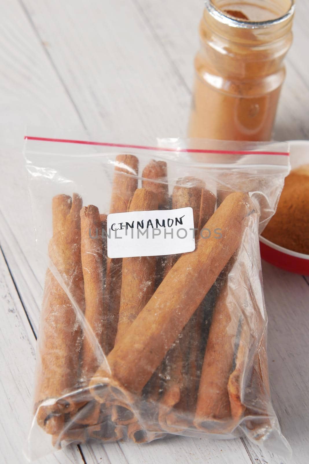 Cinnamon sticks and cinnamon powder on white background