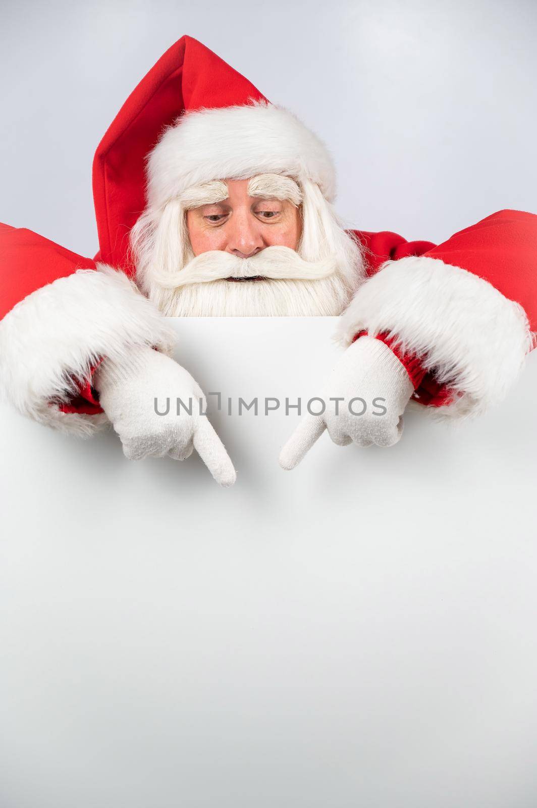 Santa Claus points to white copy space. Advertising. Merry Christmas. by mrwed54