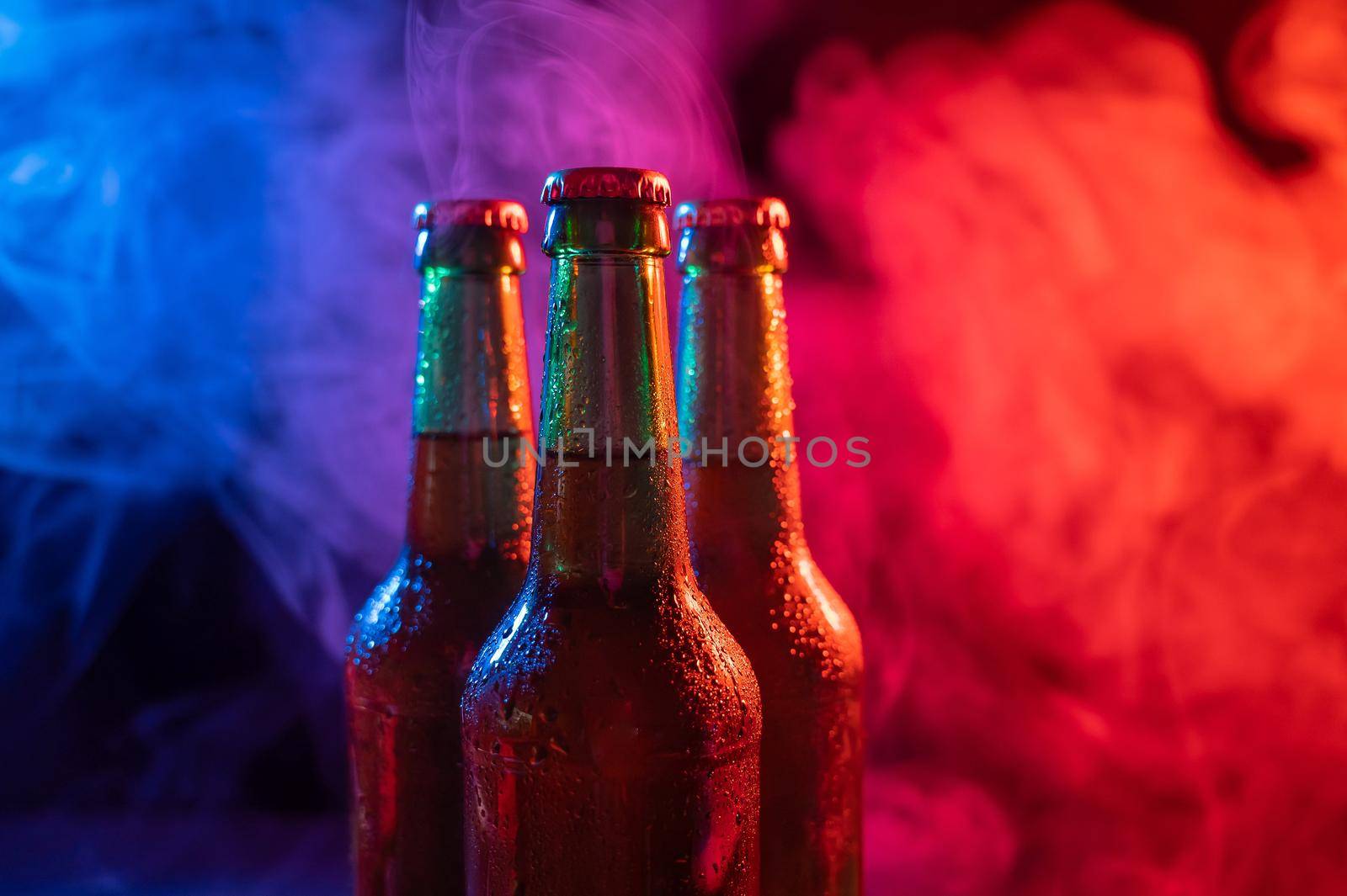Three bottles of beer in a blue-pink mist. by mrwed54