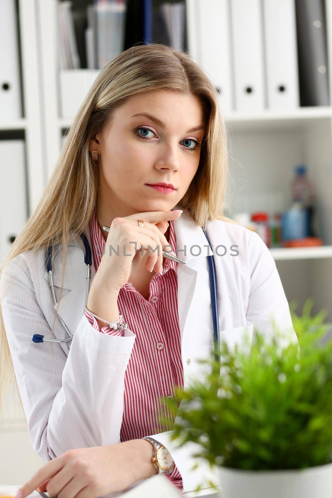 Beautiful smiling female doctor sit at workplace. Physical and disease prevention, patient aid, exam visit, 911, ward round, prescribe remedy, healthy lifestyle, consultant profession concept