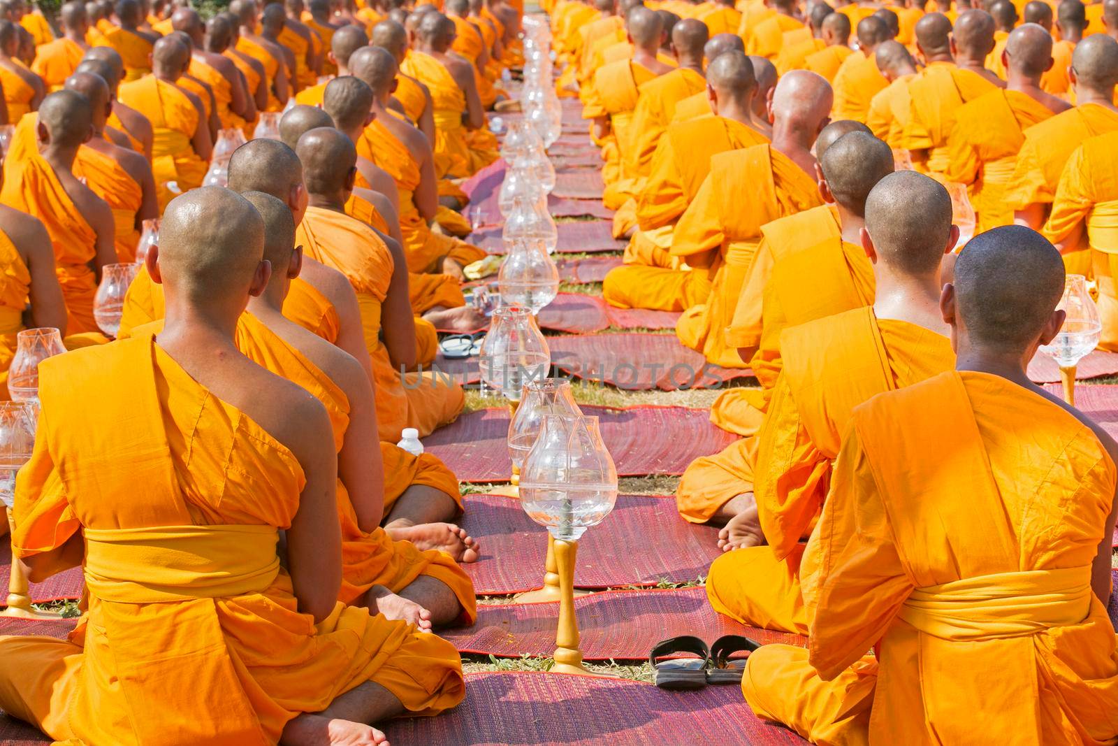 Buddhist monks pray to Buddha and candles in Chiang Rai