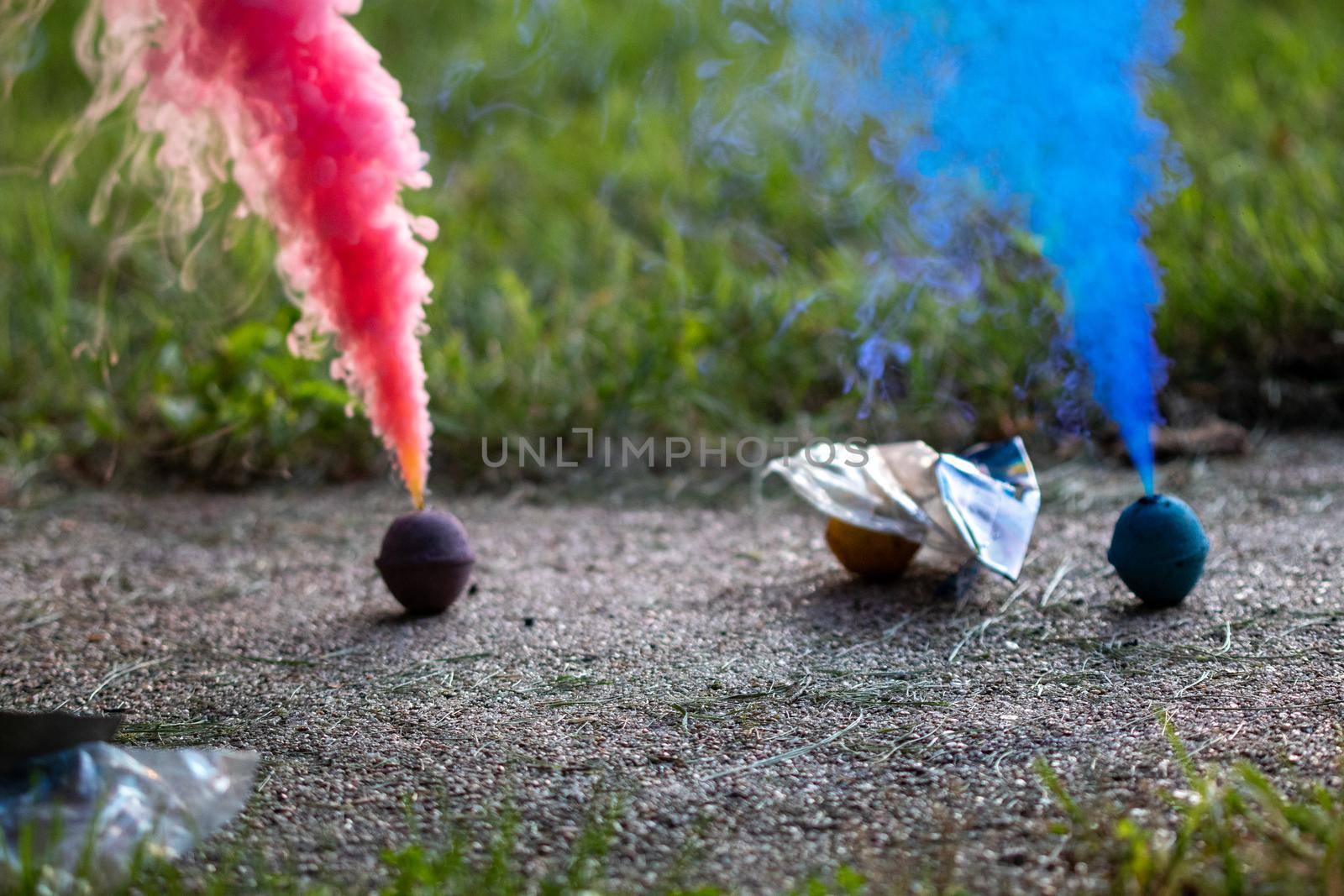 Vibrant colorful display of Red and Blue smoke bombs celebrating independence day with textured background 4th of July . Shows artistic use of color and design. by gena_wells