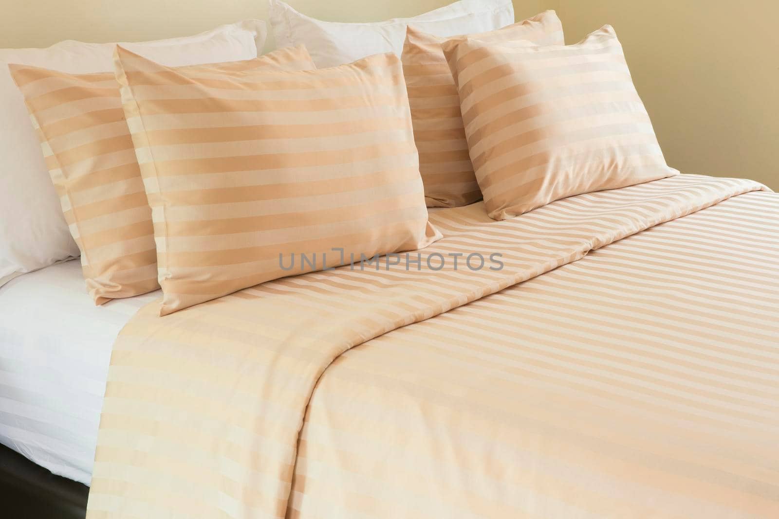 Comfortable soft pillows on the bed by titipong